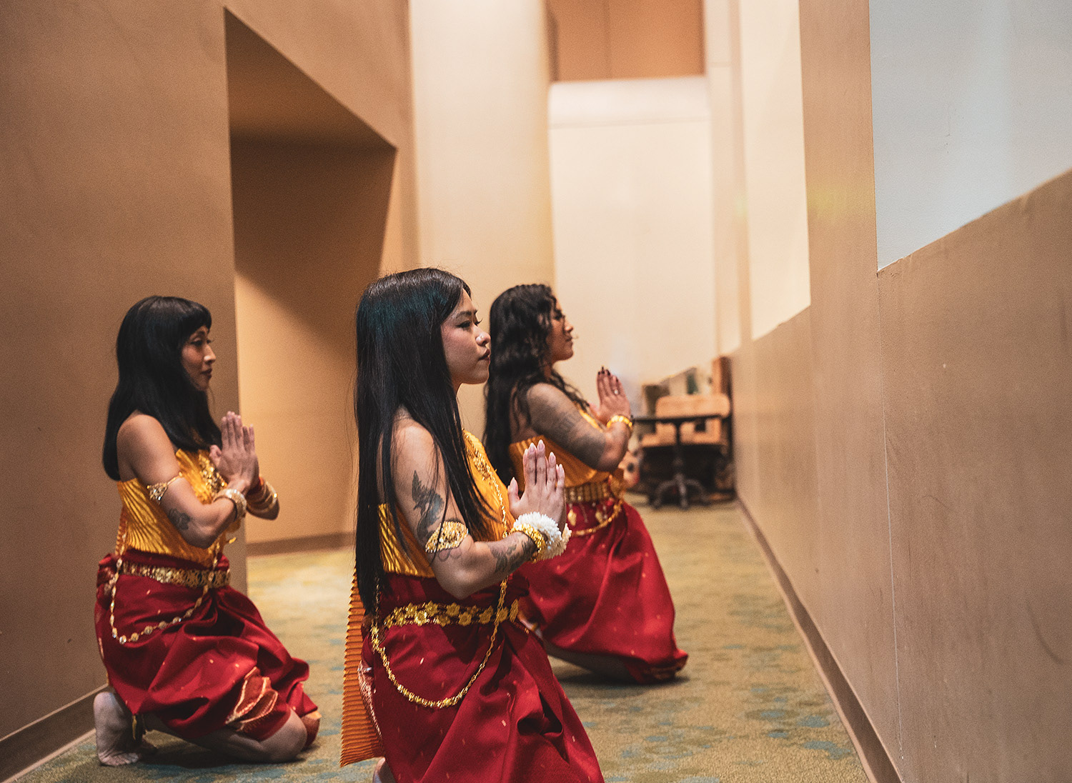 The dancers find a narrow hallway to practice the routine before the dress rehearsal.