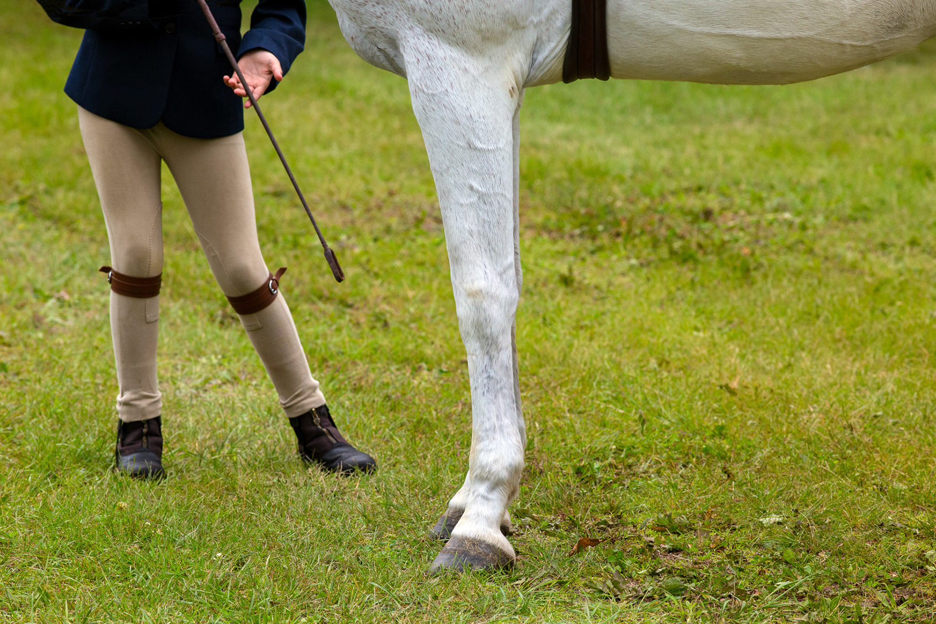 Teenager with horse at show in Connecticut, USA