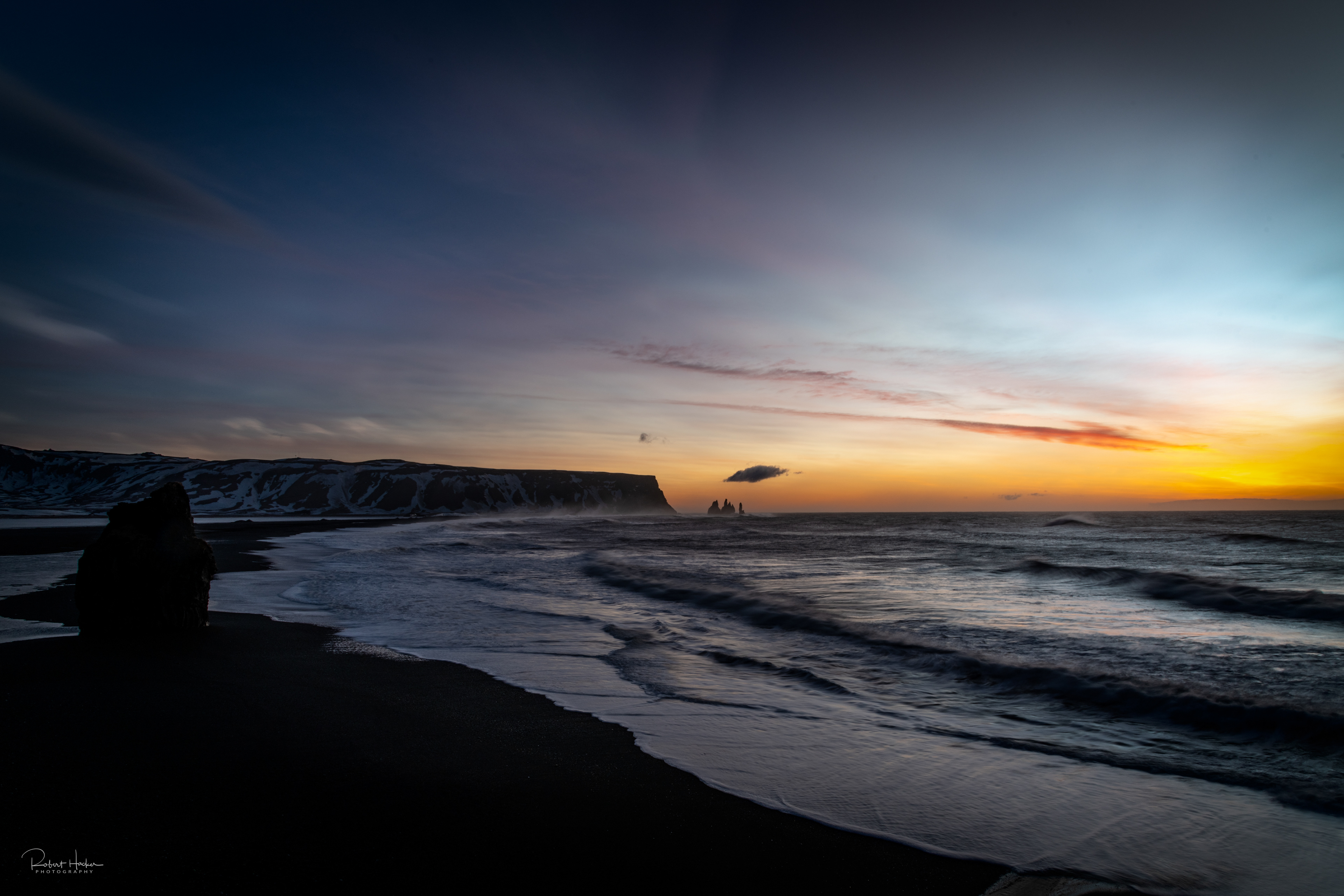 Sunrise at the Kirkjufjara Beach Overlook.  These are the same sea stacks as on the black sand beach in Vik