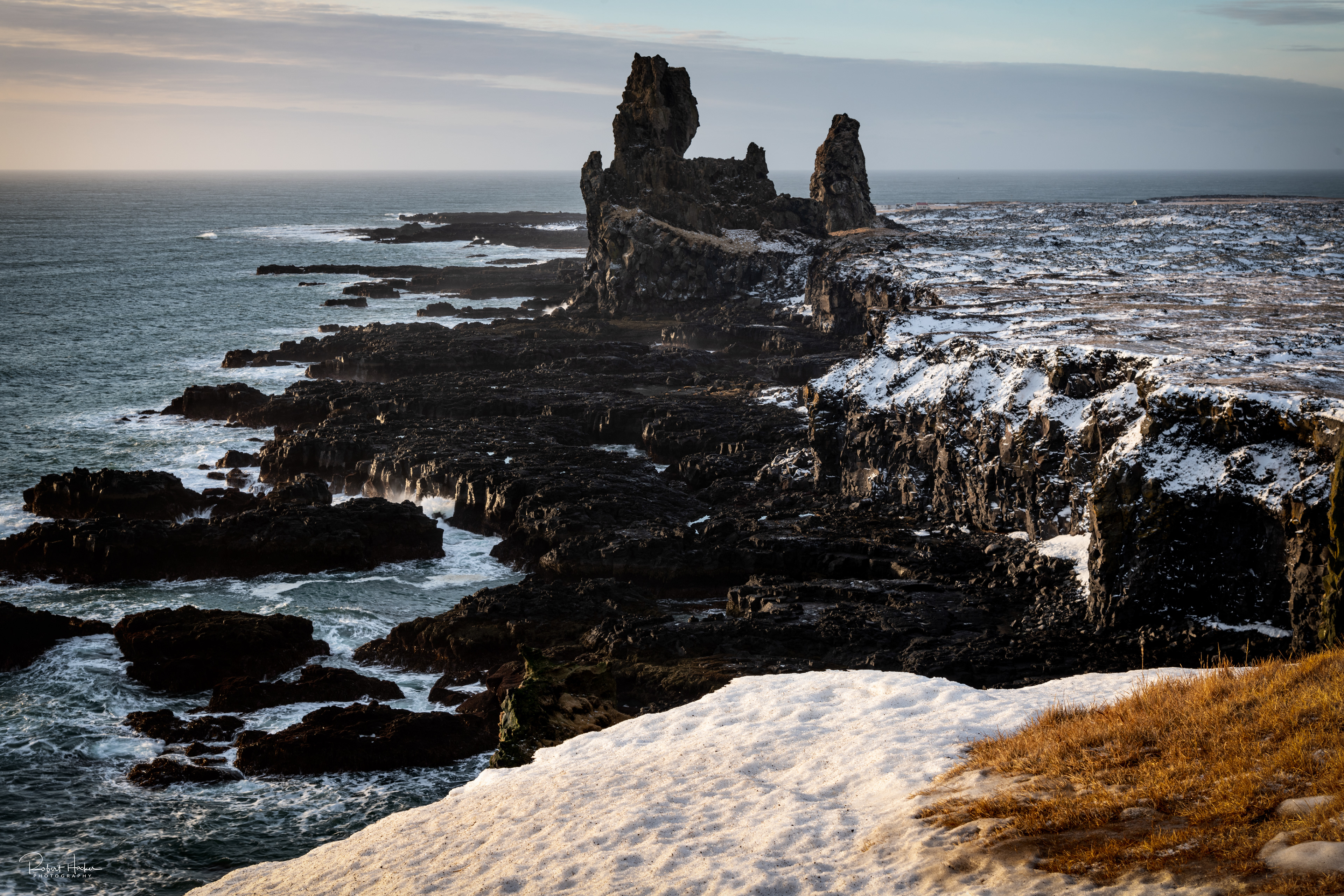 Lóndrangar Basalt Cliffs, the remains of a crater which has been eroded to its present form by the sea
