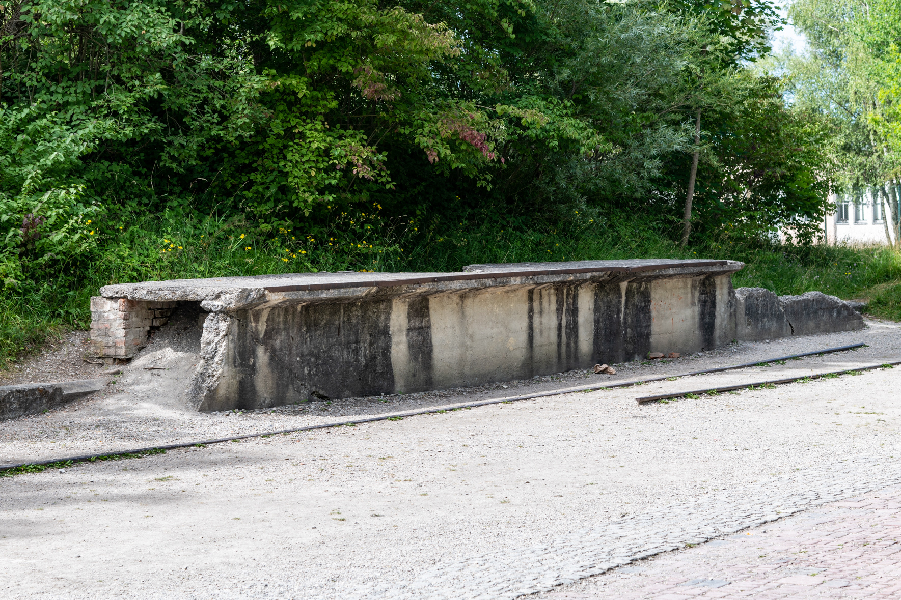 Part of the railway platform near the entrance to the camp. This platform and rail siding were not used to transport prisoners to Dachau. The prisoners were unloaded in Dachau's main rail station and forced to walk through town to the camp.