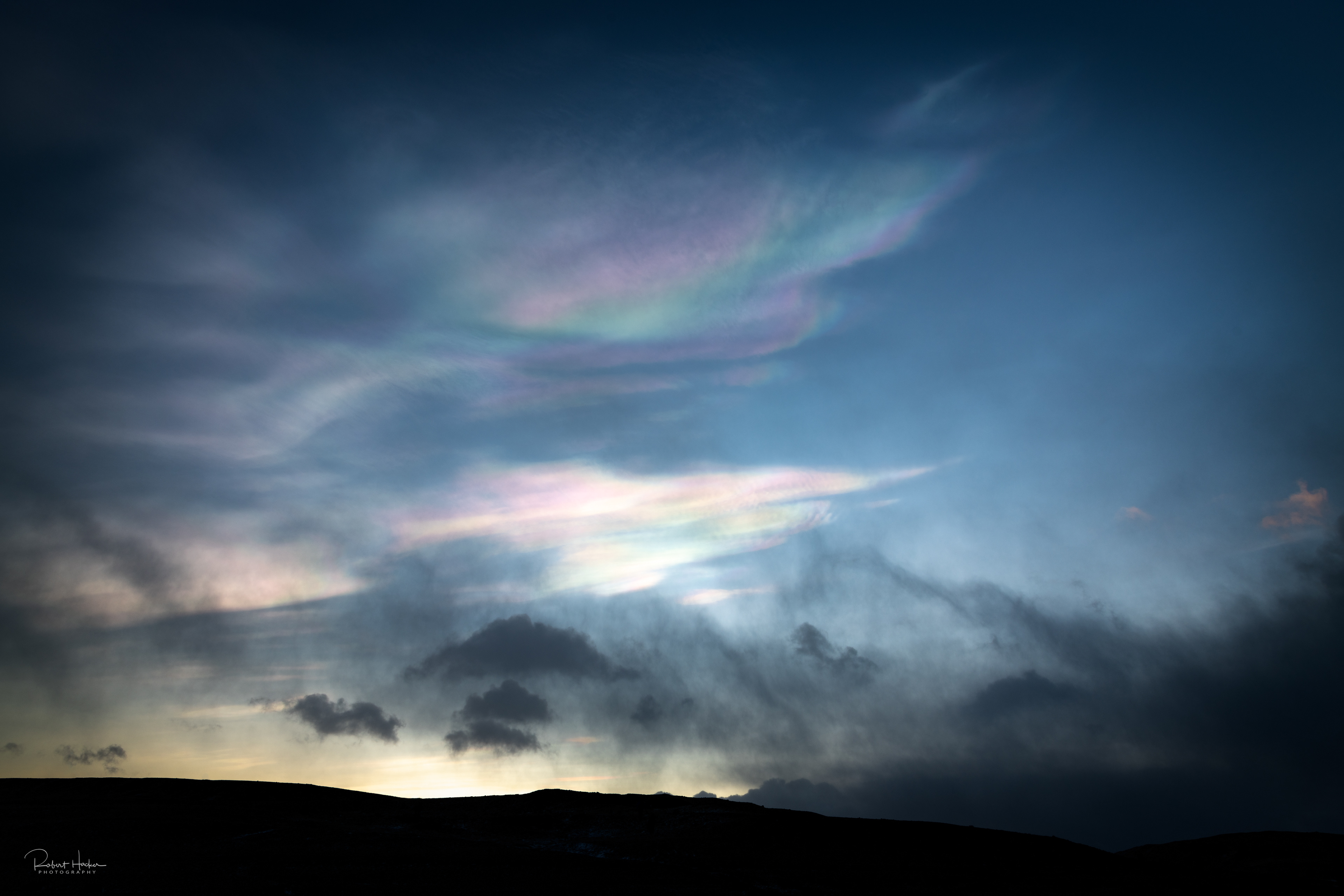 Nacreous clouds (Mother-of-Pearl clouds) at sunrise, Fjallsárlón Glacier lagoon.  Nacreous clouds form in very cold conditions over polar  regions and within the stratosphere, around 12 to 19 miles high.
