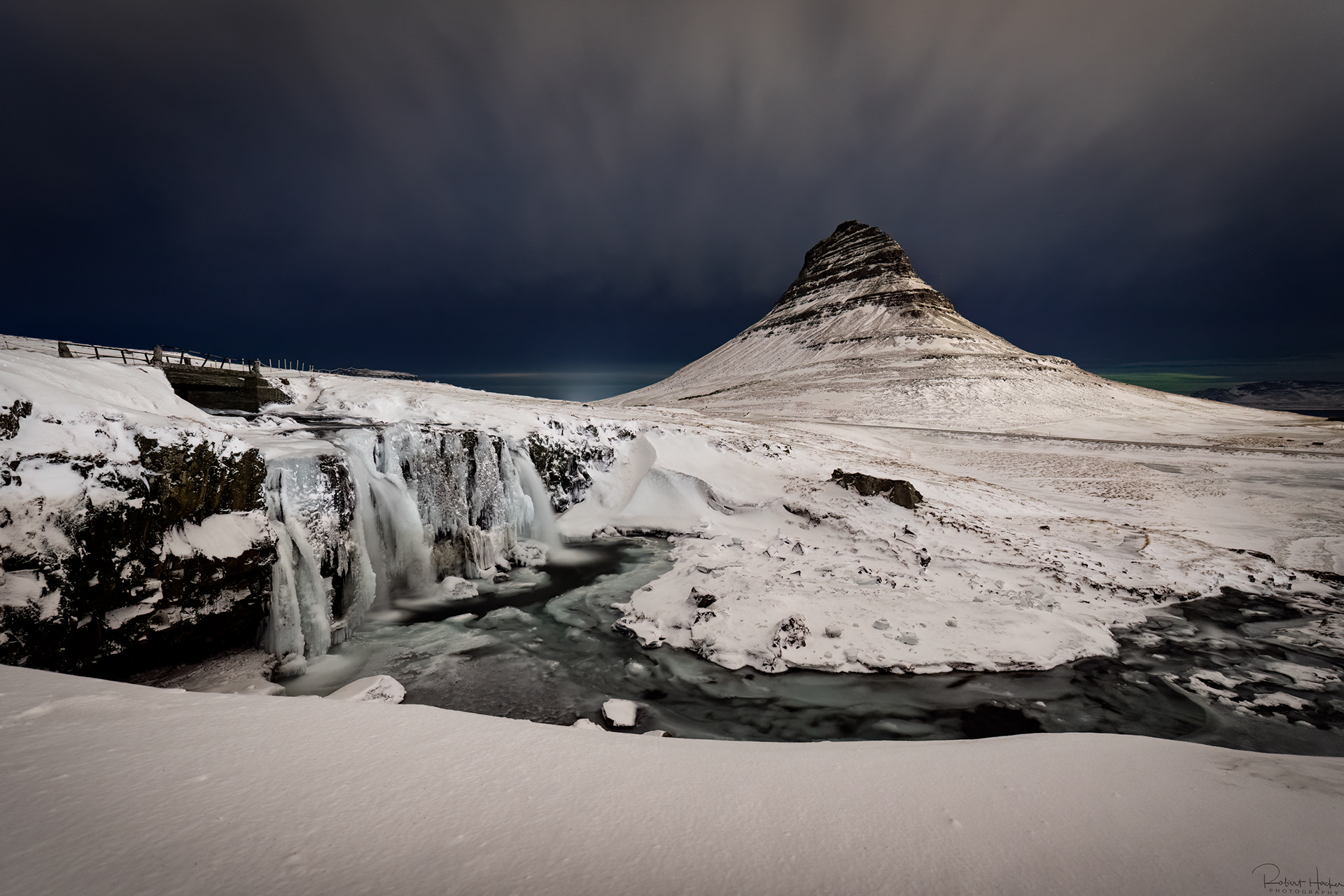 Night shot of with a touch of Northern Lights at Kirkjufellsfoss and Kirkjufell on the Snaefellsnes Peninsula
