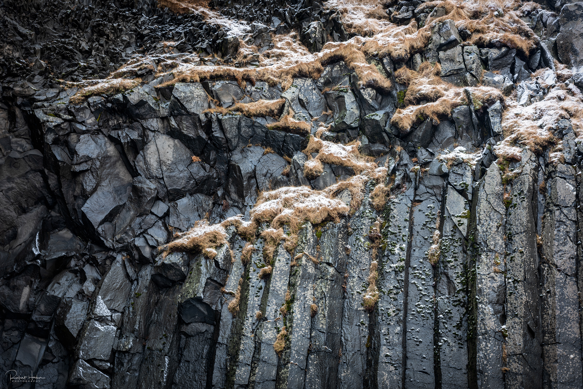 Basalt cliffs and crashing surf at Reyniskirkja Beach