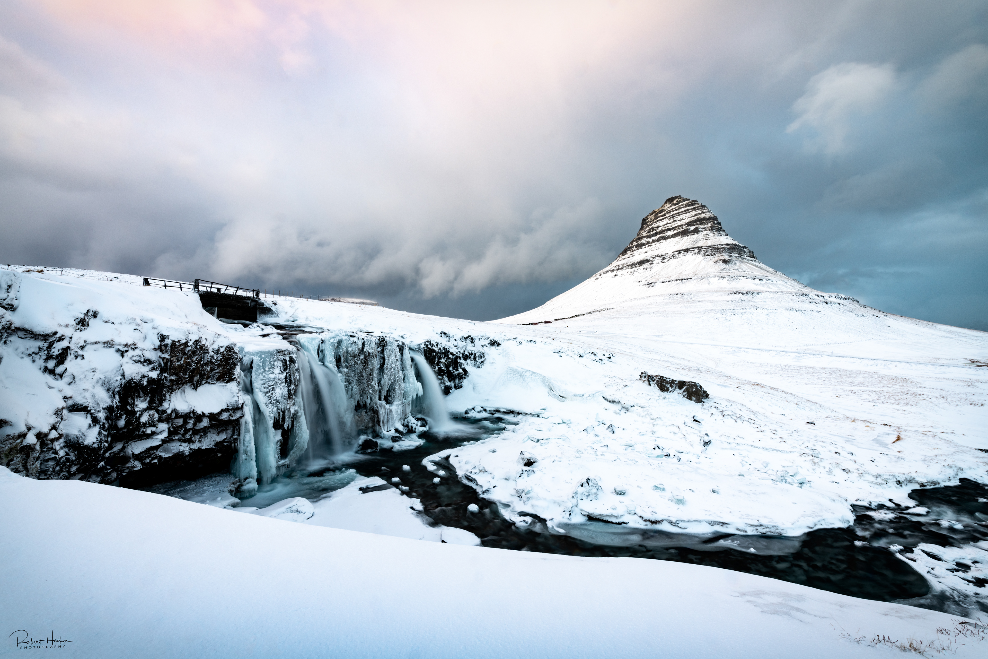 Kirkjufellsfoss that channels the glacial water of Snaefellsjokull glacier and Kirkjufell on the Snaefellsnes Peninsula 