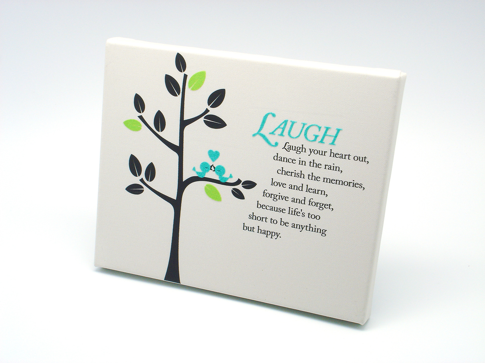 Laugh inspirational quote and birds in tree graphic on off white canvas material.