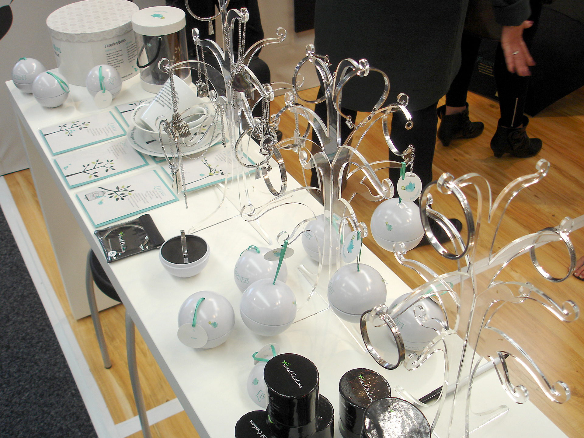 Vivant Creations trade show stand table displaying various products spanning multiple ranges.