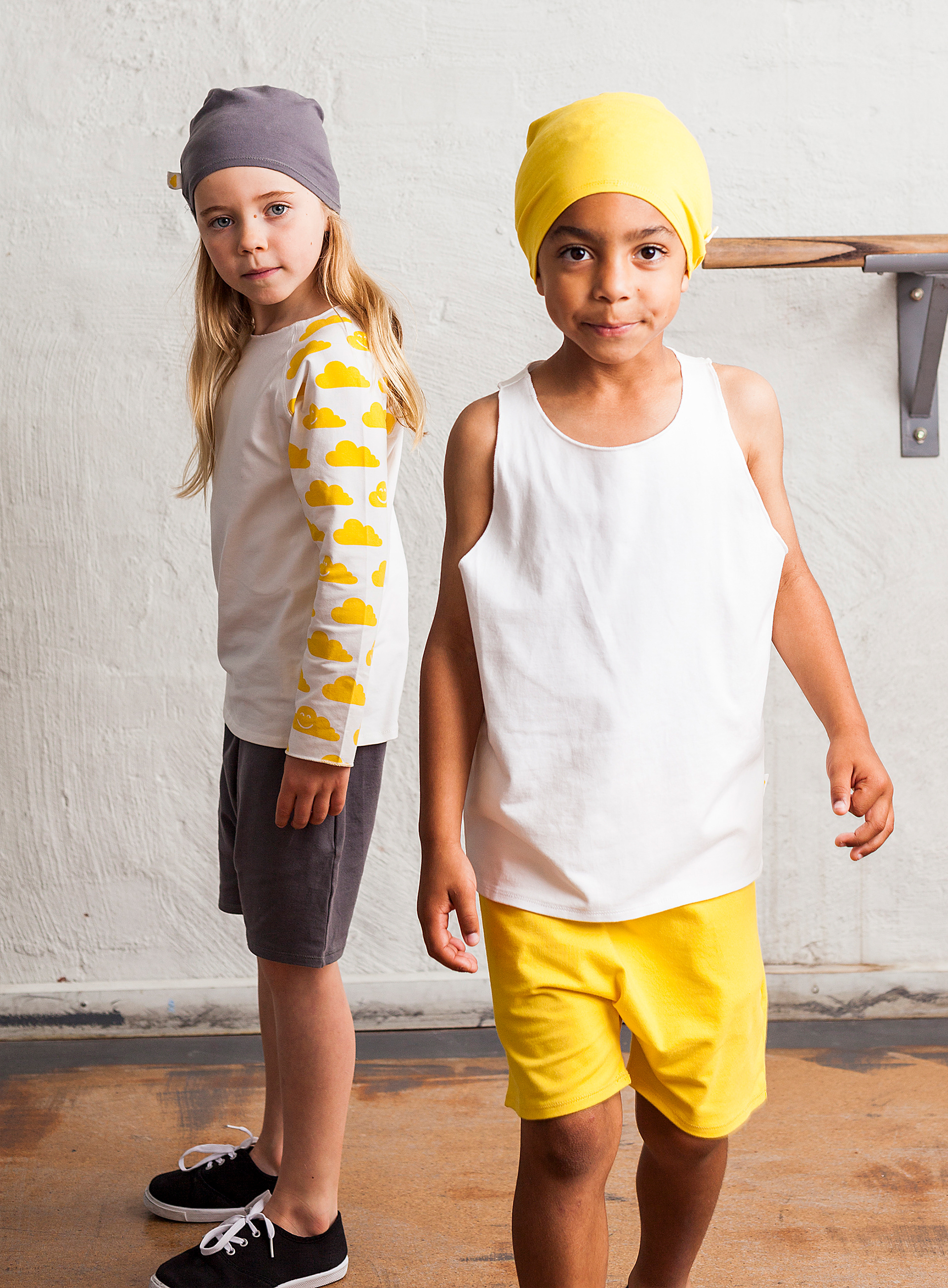 Young girl and boy wearing Little Yellow Cloud clothing.
