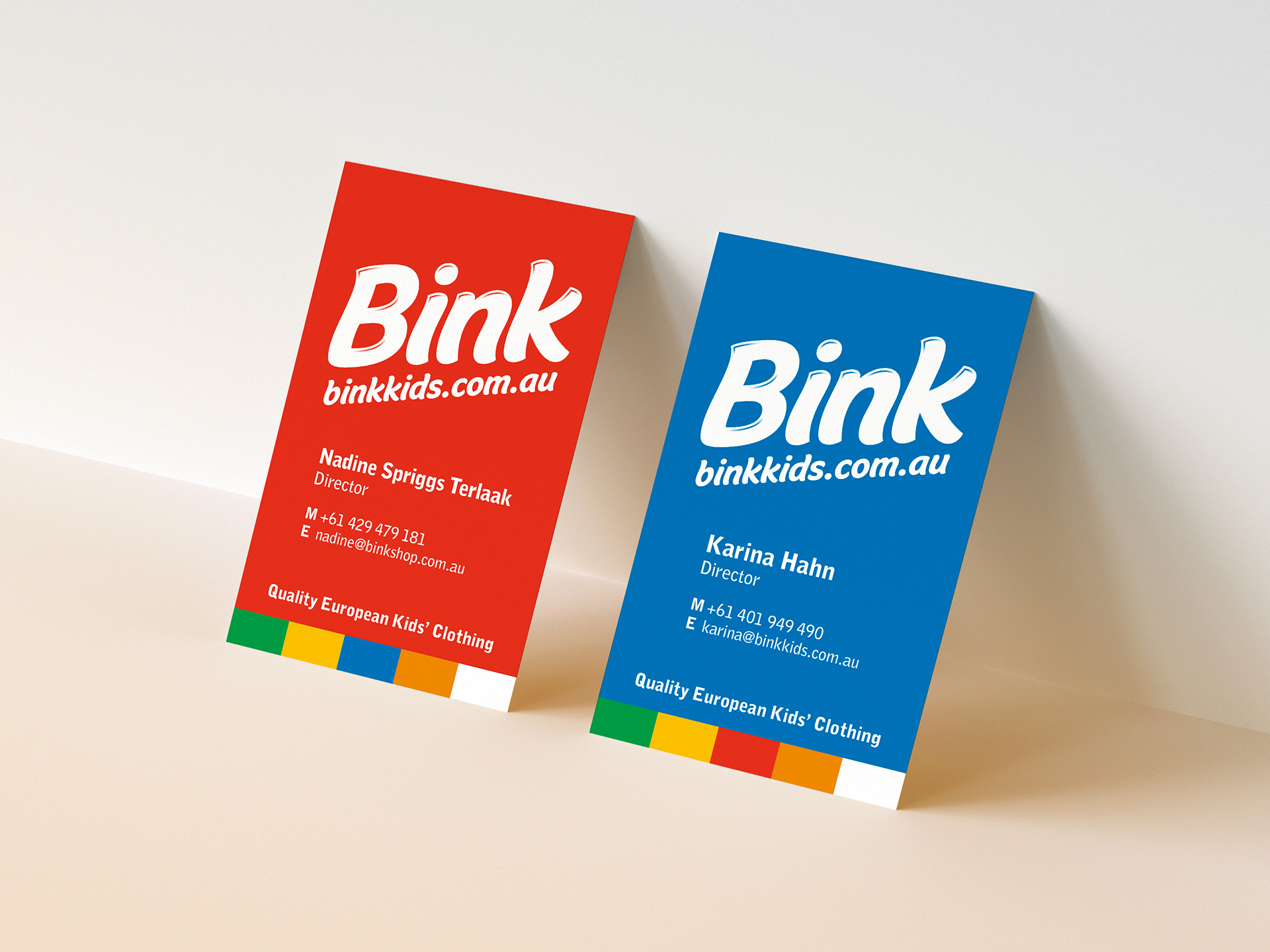 Bink Kids business cards with Bink Kids logo reversed white out of red and blue backgrounds.