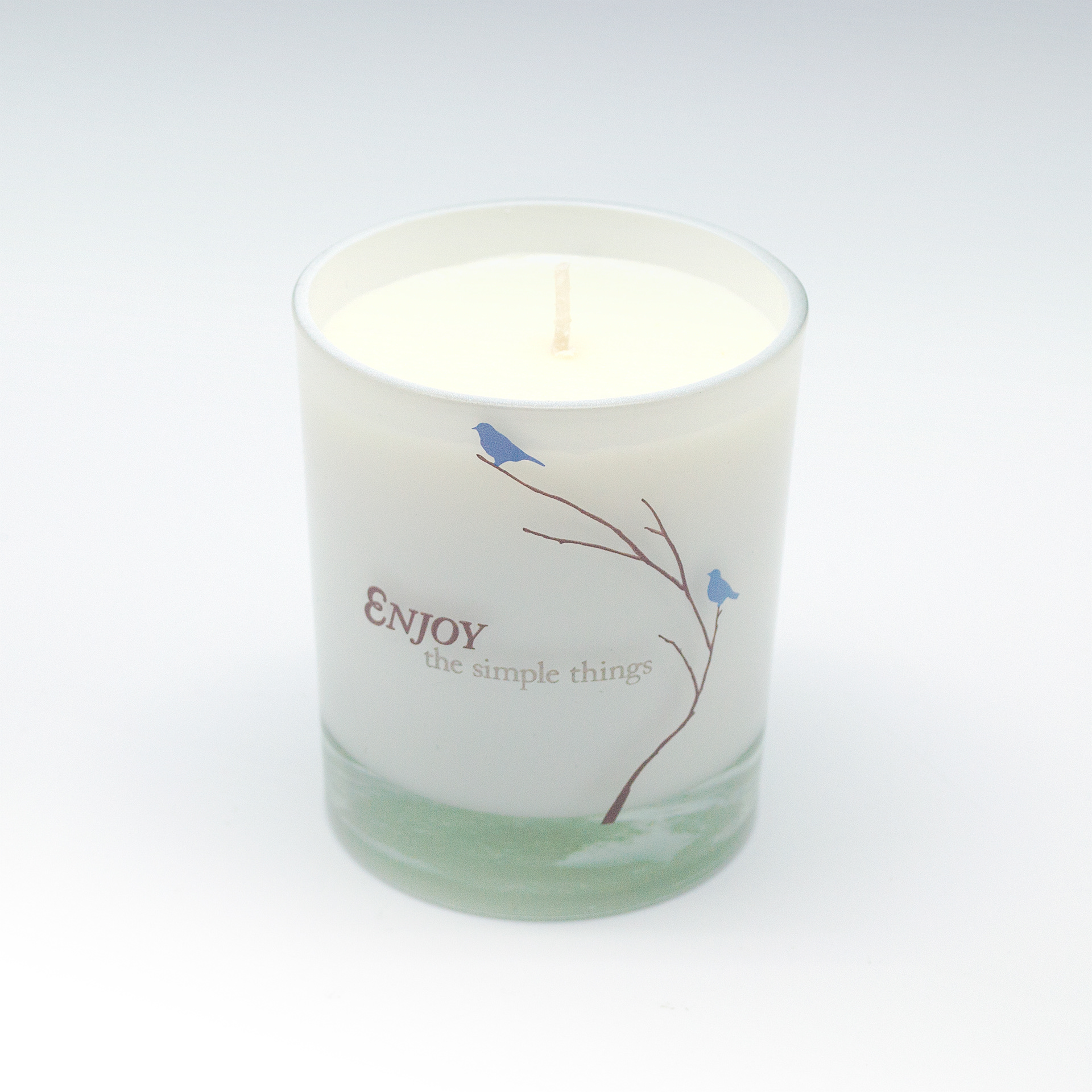 Enjoy - type and illustration composition on scented candle glass container.