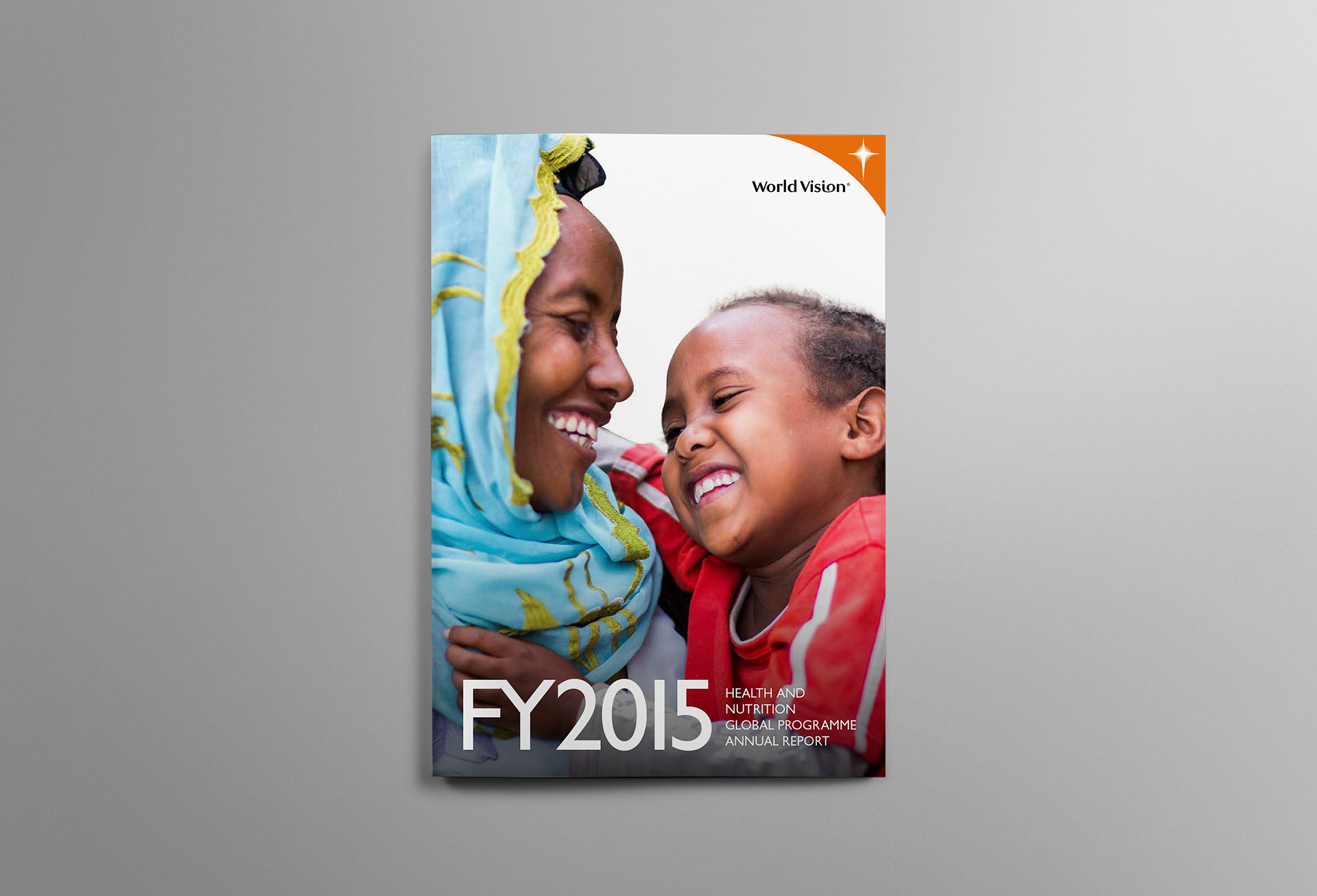 Front cover of the World Vision 2015 Annual Report with smiling mother and child full bleed image.