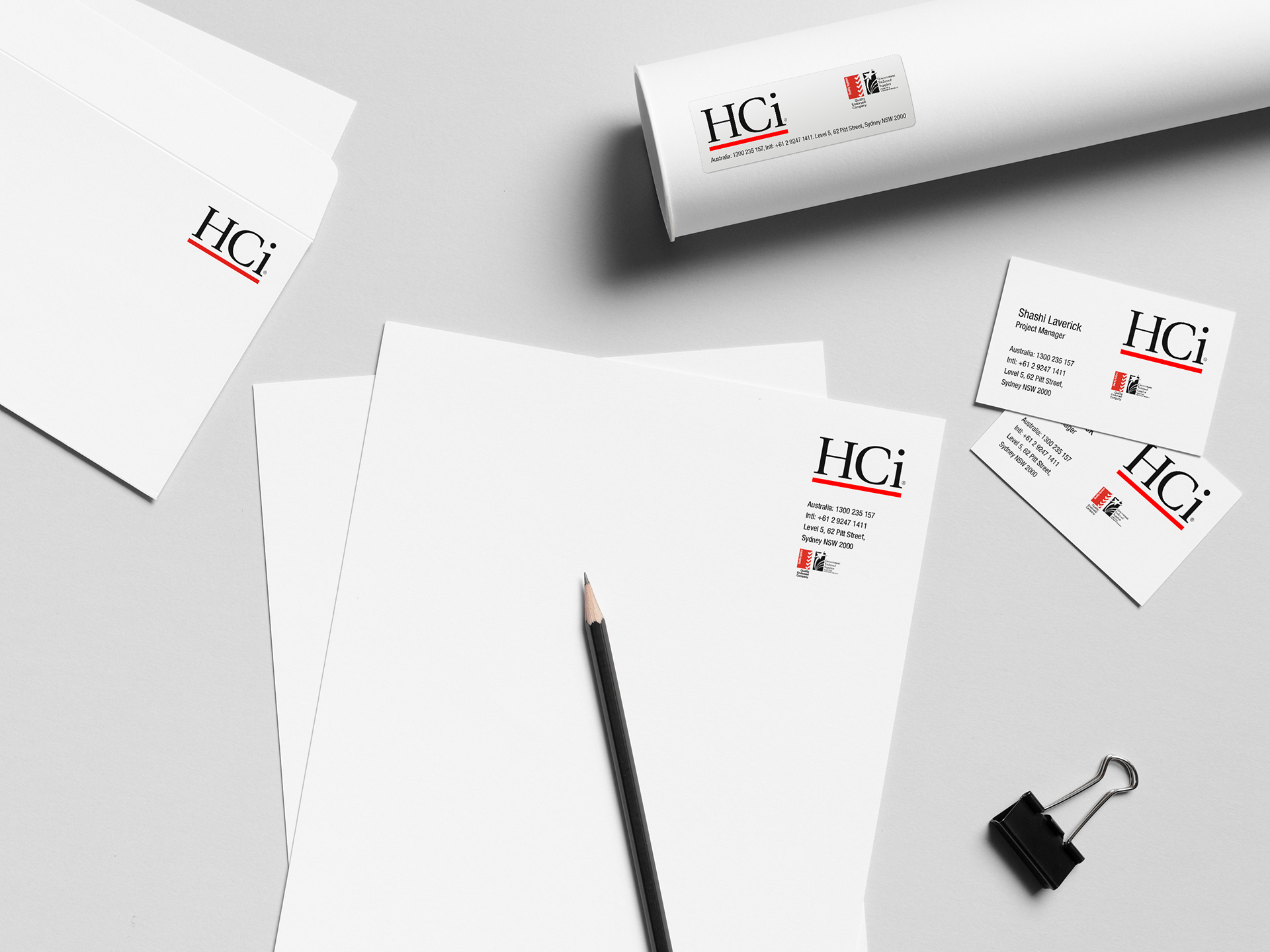 A range of HCi stationery items spread across a table.