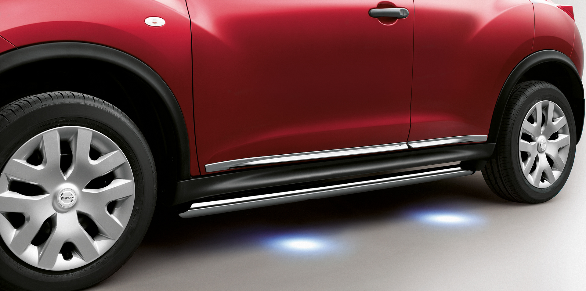Tight crop of red Nissan Juke showing the under-car lighting.