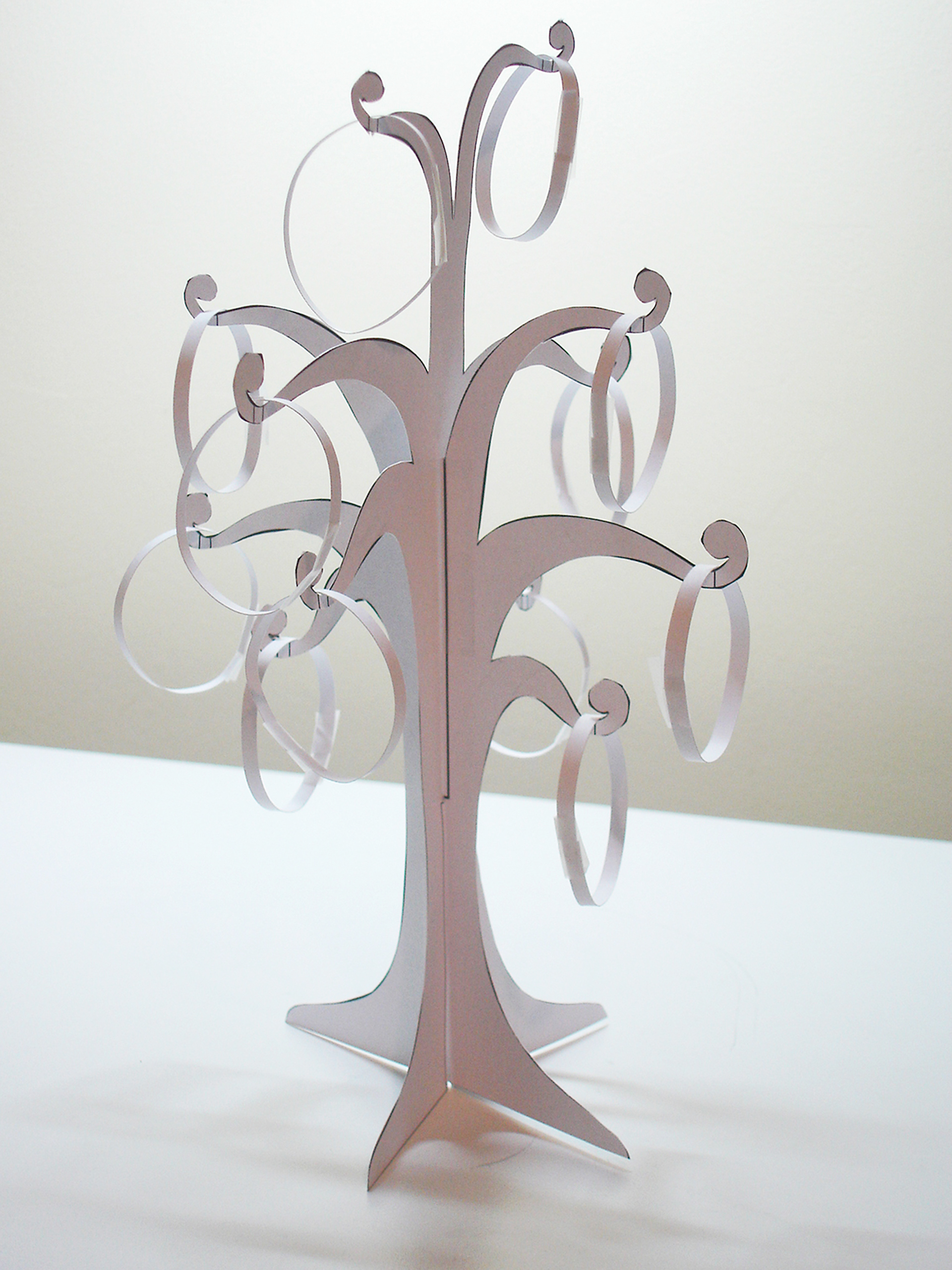Paper model of the jewellery stand tree shape with paper bracelets hanging in place.