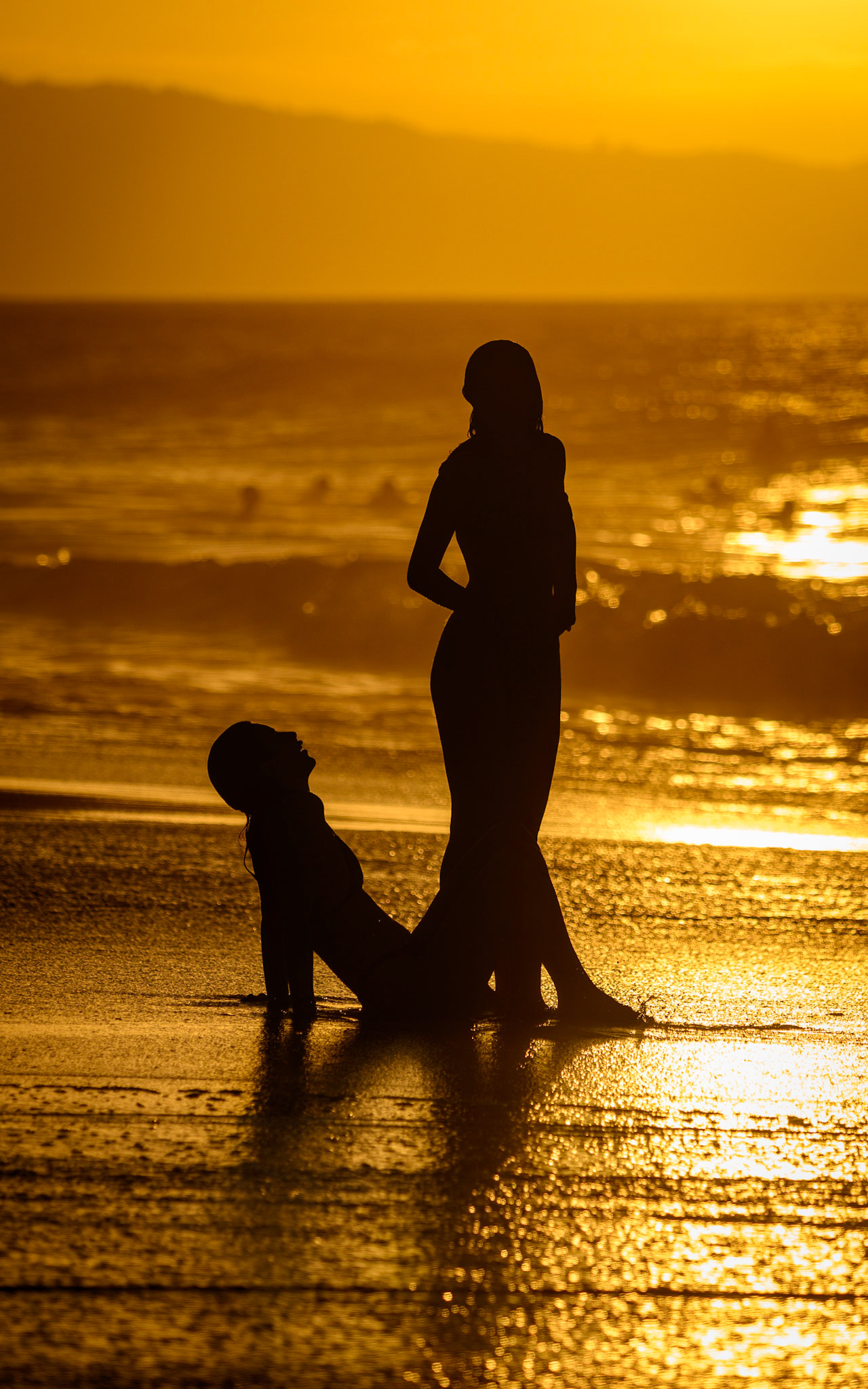 Two friends basking in the Hawaiian Sunset on Sunset Beach, North Shore