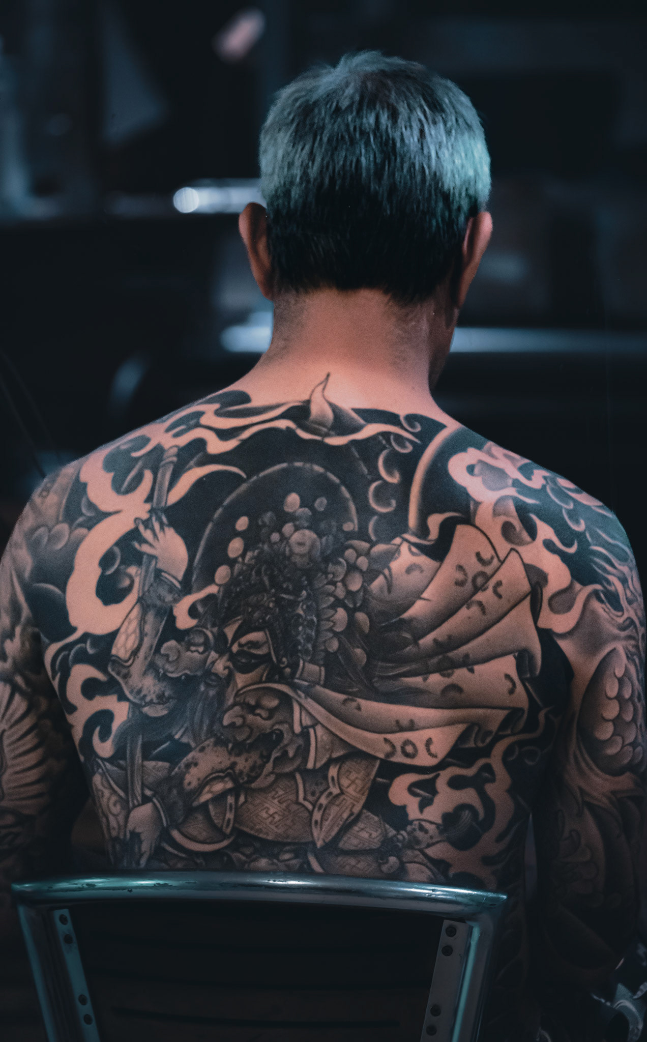 Unknown Person sitting shirtless in Waikiki