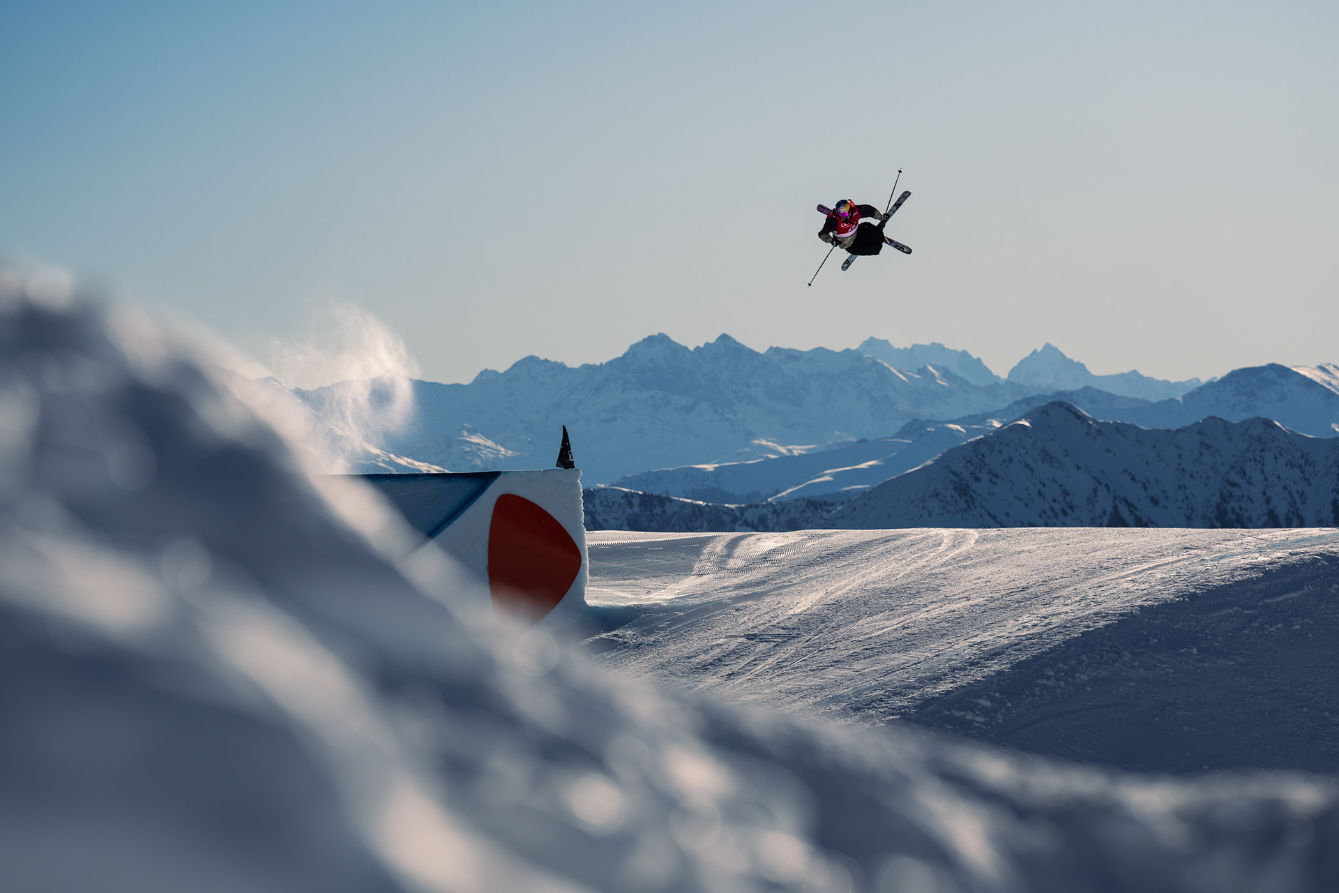 Fabian Bösch flying high above the Swiss Alps during the Laax Open Ski Slopestyle 2025. Red Bull, O'Neill Europe, Laax