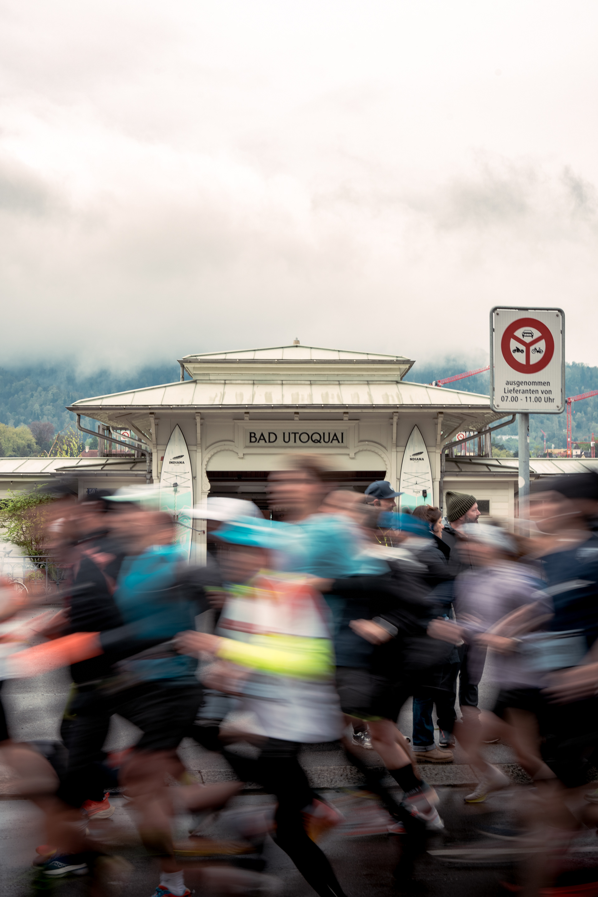Zurich Marathon. A photograph of many runners, blurred as they run in-front of a swim bad on the Zurich waterfront.
