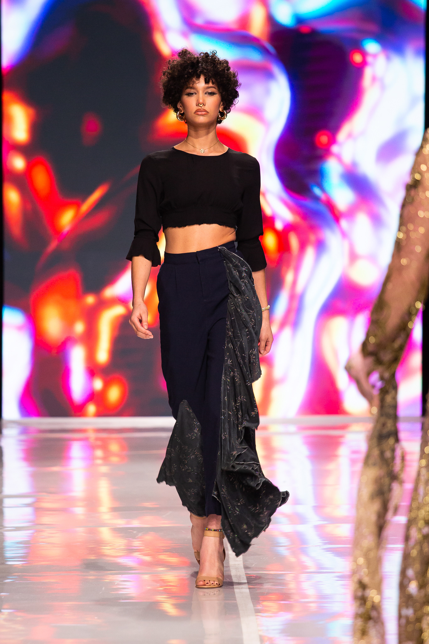 A Recycling garment with the use of extra fabric draped on the pant.