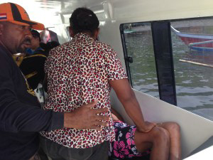 Injured Ambai Woman in Speedboat