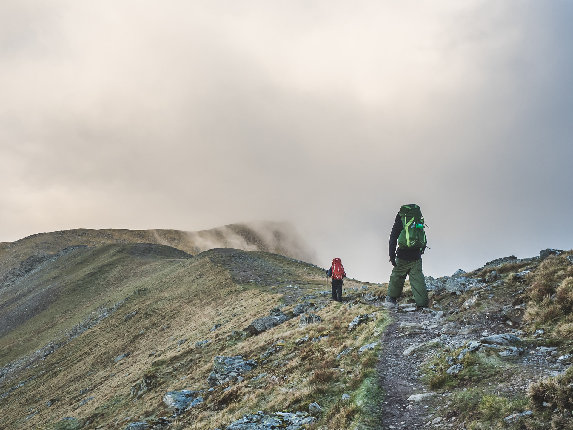 Hiking over a mountain the clouds