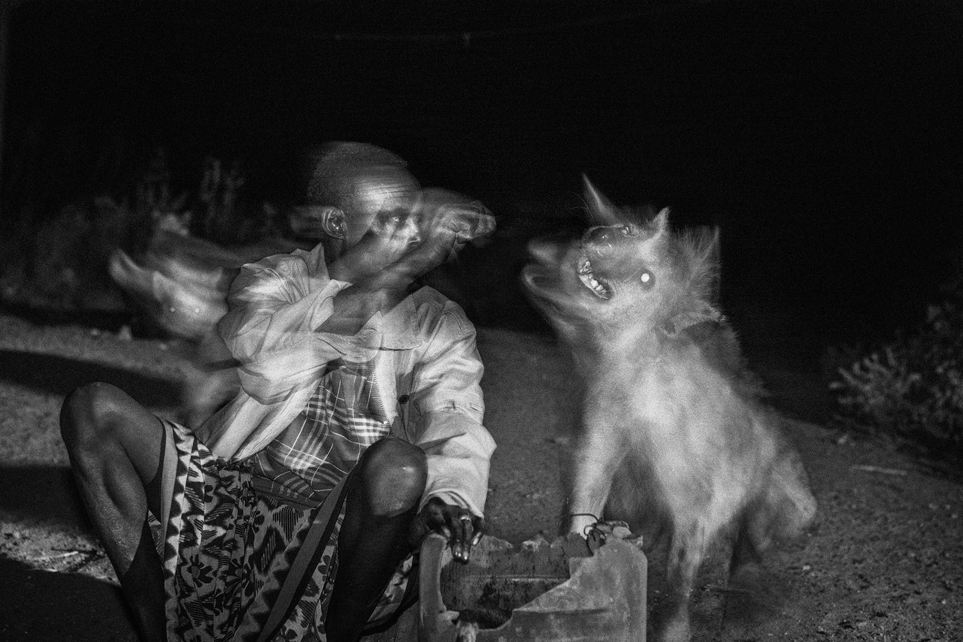 Man encounters hyenas, Harar, Ethiopia