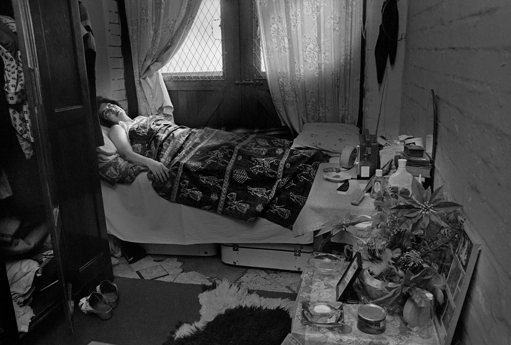 Woman sick in bed in her makeshift room, a garage. She faced eviction for living in a white area because whe was not working as a 'servant'.