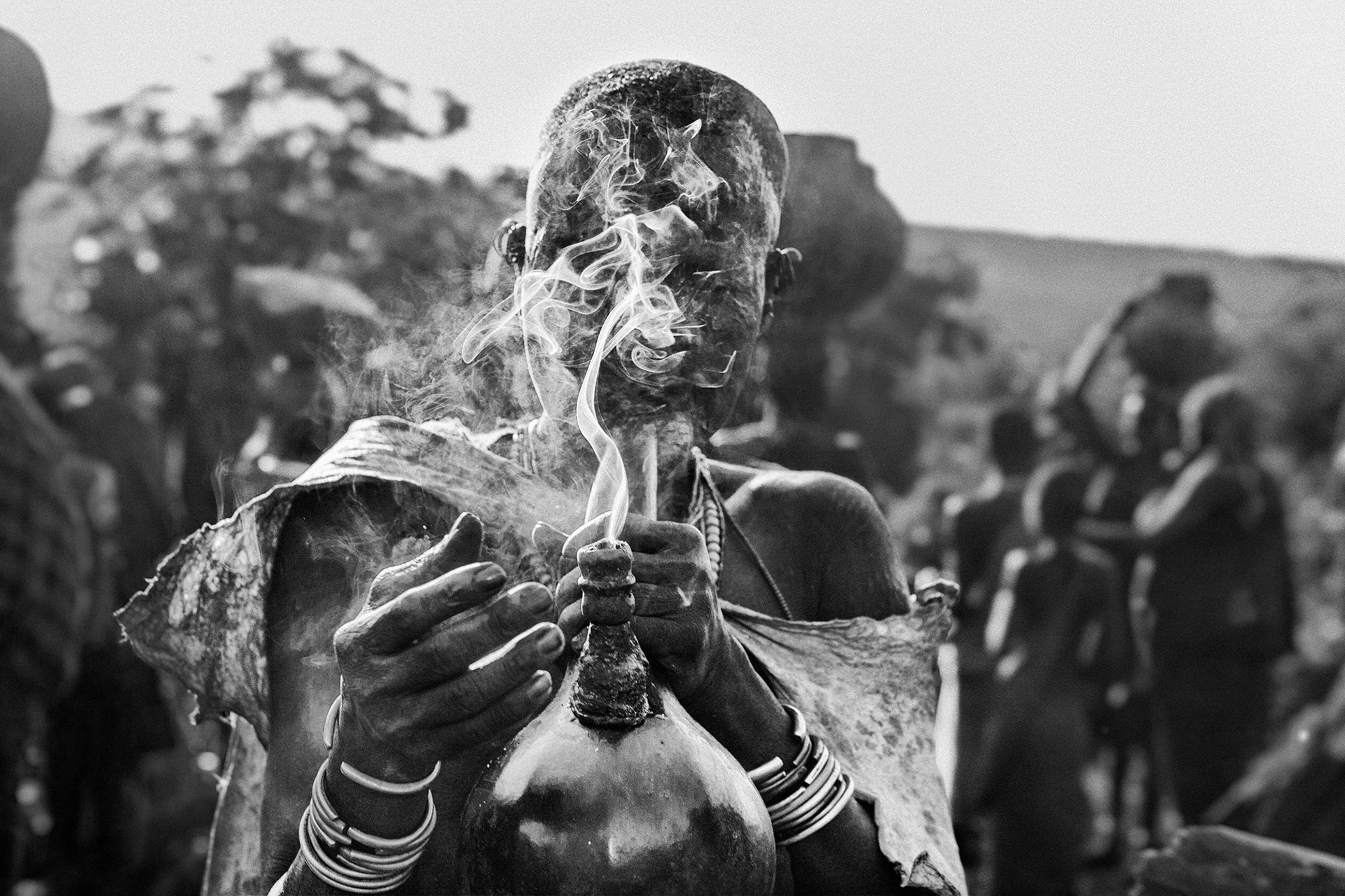 Woman smokes pipe, Omo Valley, Ethiopia
