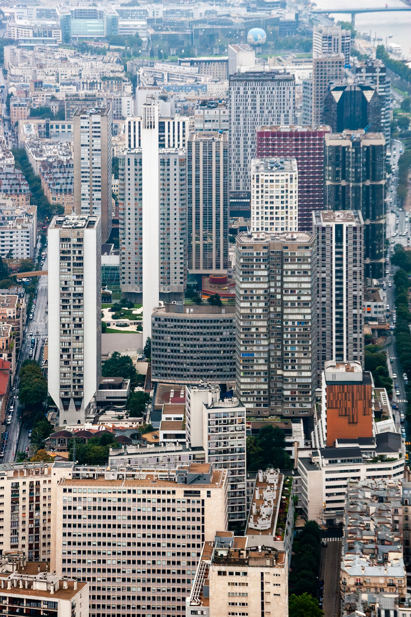 A high-angle vertical view of the Front de Seine district in Paris, France, featuring a cluster of brutalist and modern residential skyscrapers and office towers under an overcast sky.
