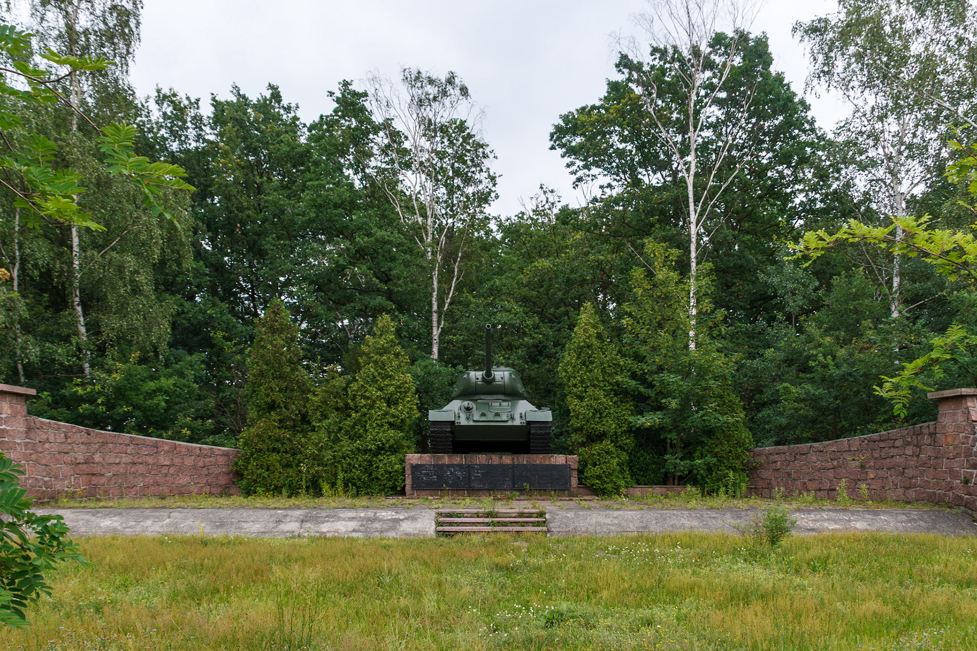 Historic military tank monument in a forest glade