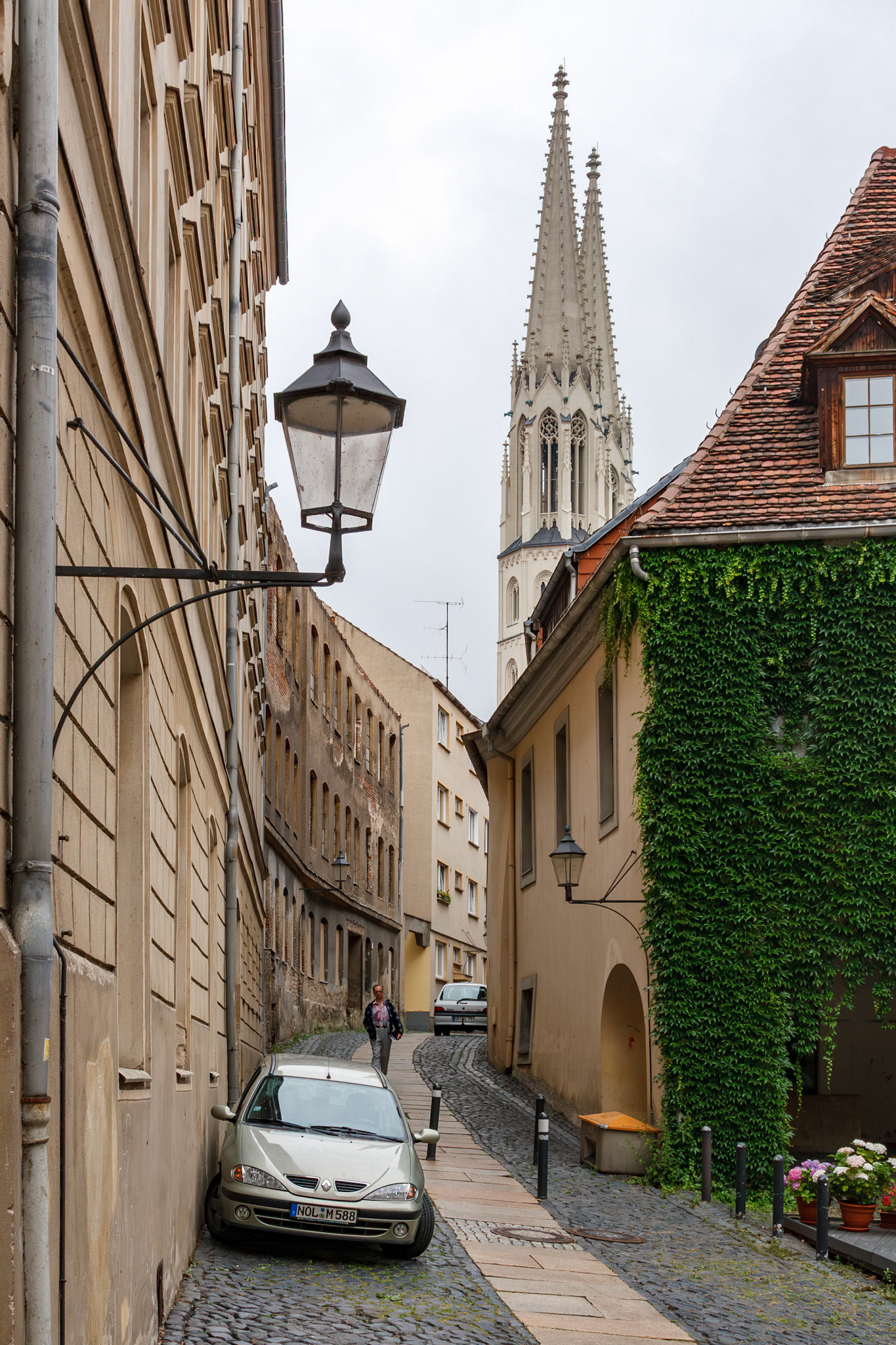 Church spire towering over old town alley