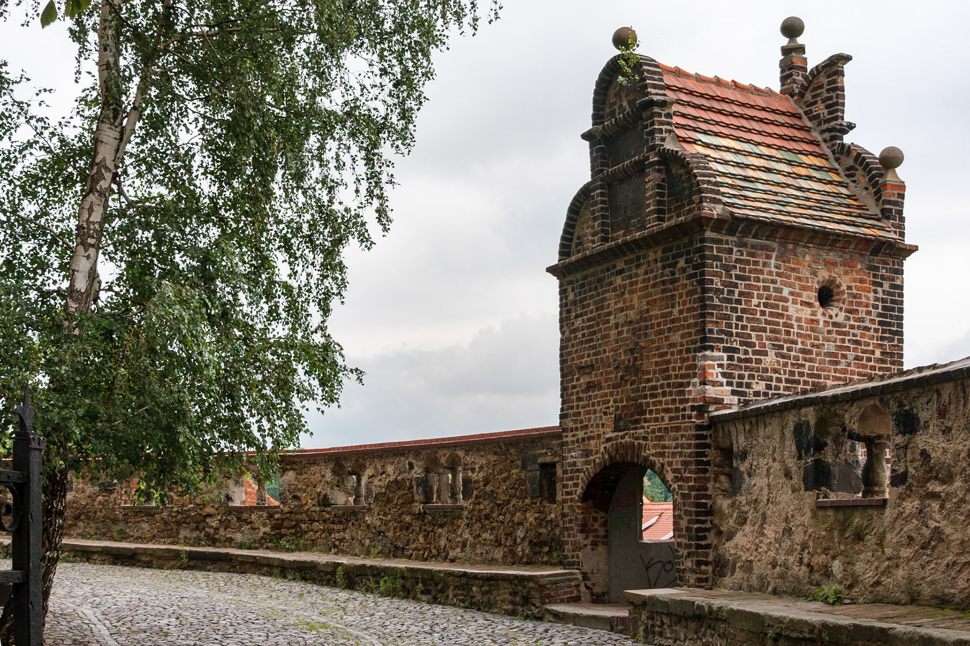 Old stone wall with brick fortification tower