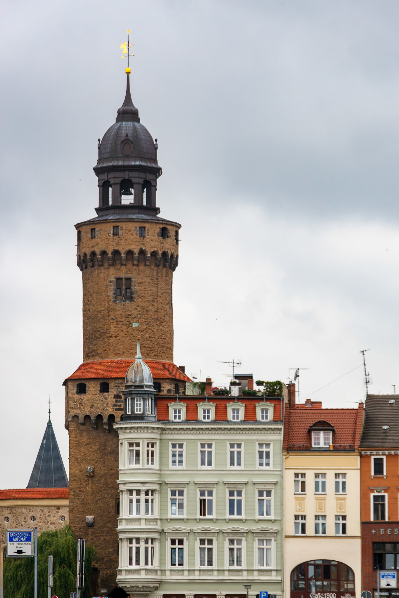 Historic stone tower rising above old town buildings