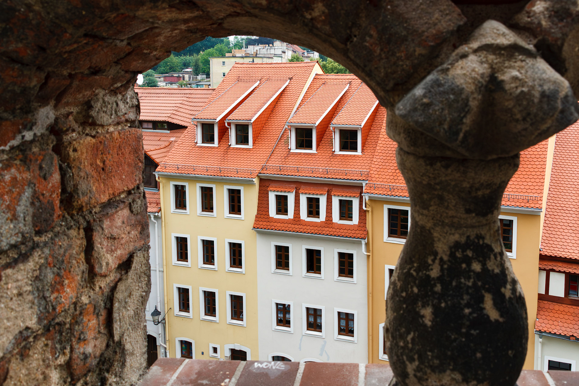 City buildings framed by stone archway