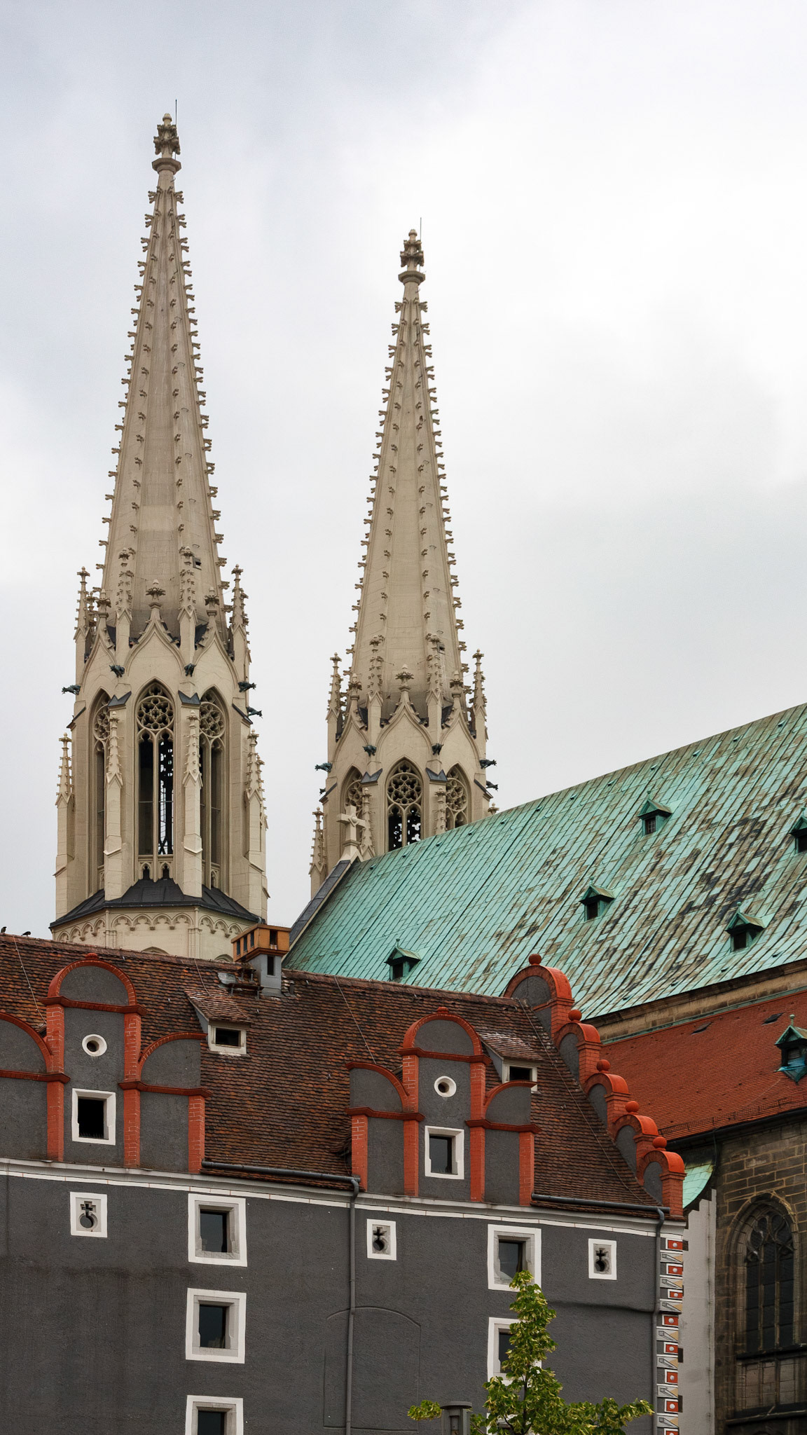 Twin church spires rising above historic roofs