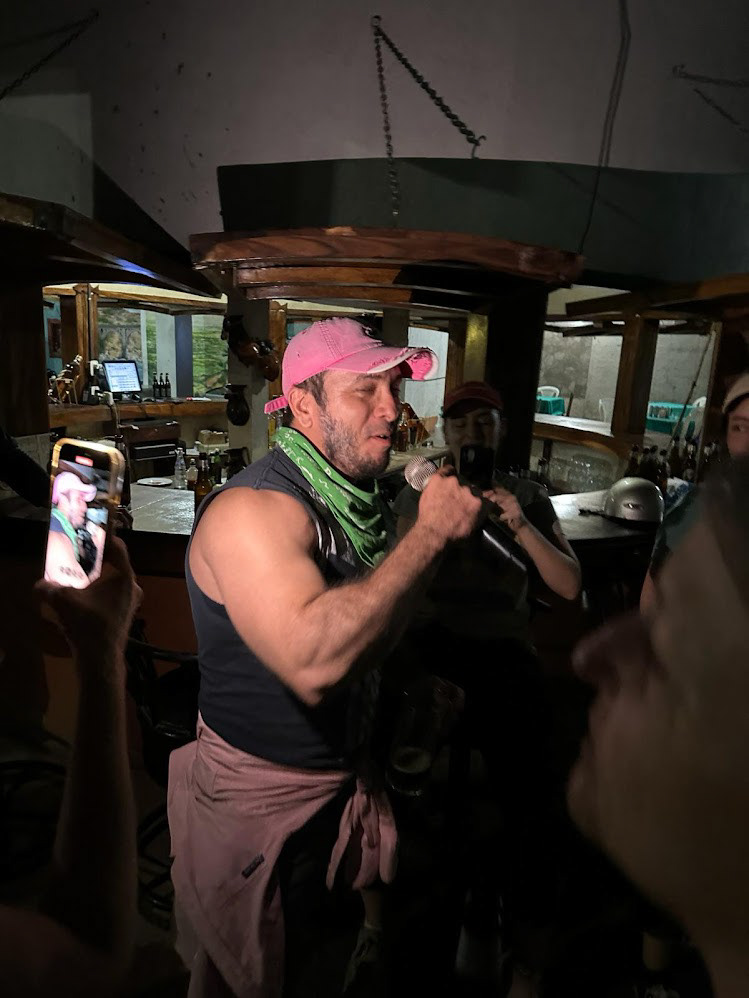 Enrique belting out "Take Me Home, Country Roads"