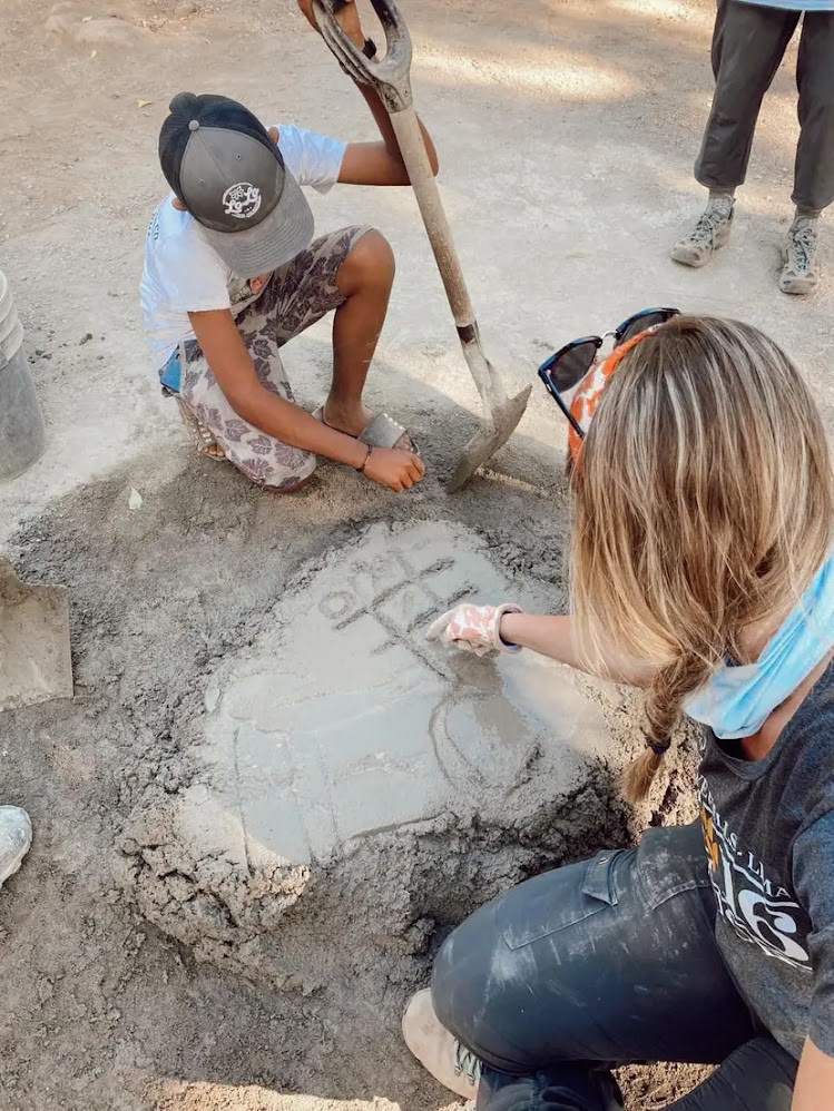 Hector and Jessica playing tic tac toe in the mortar while we wait for the bricklayers to tell us they're ready for more.