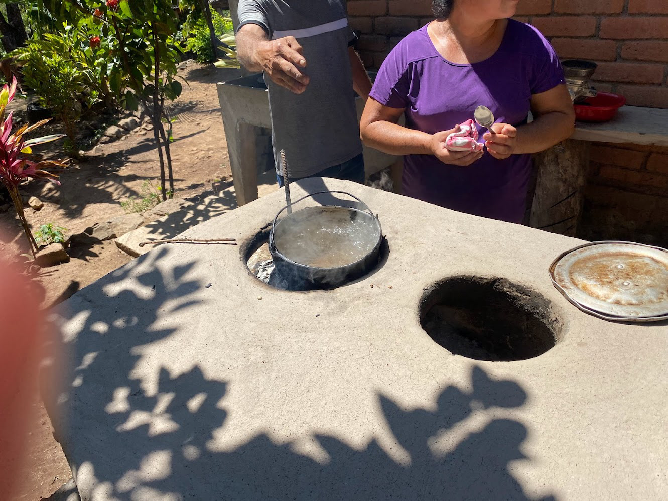 They boil the water in this handmade clay stove.