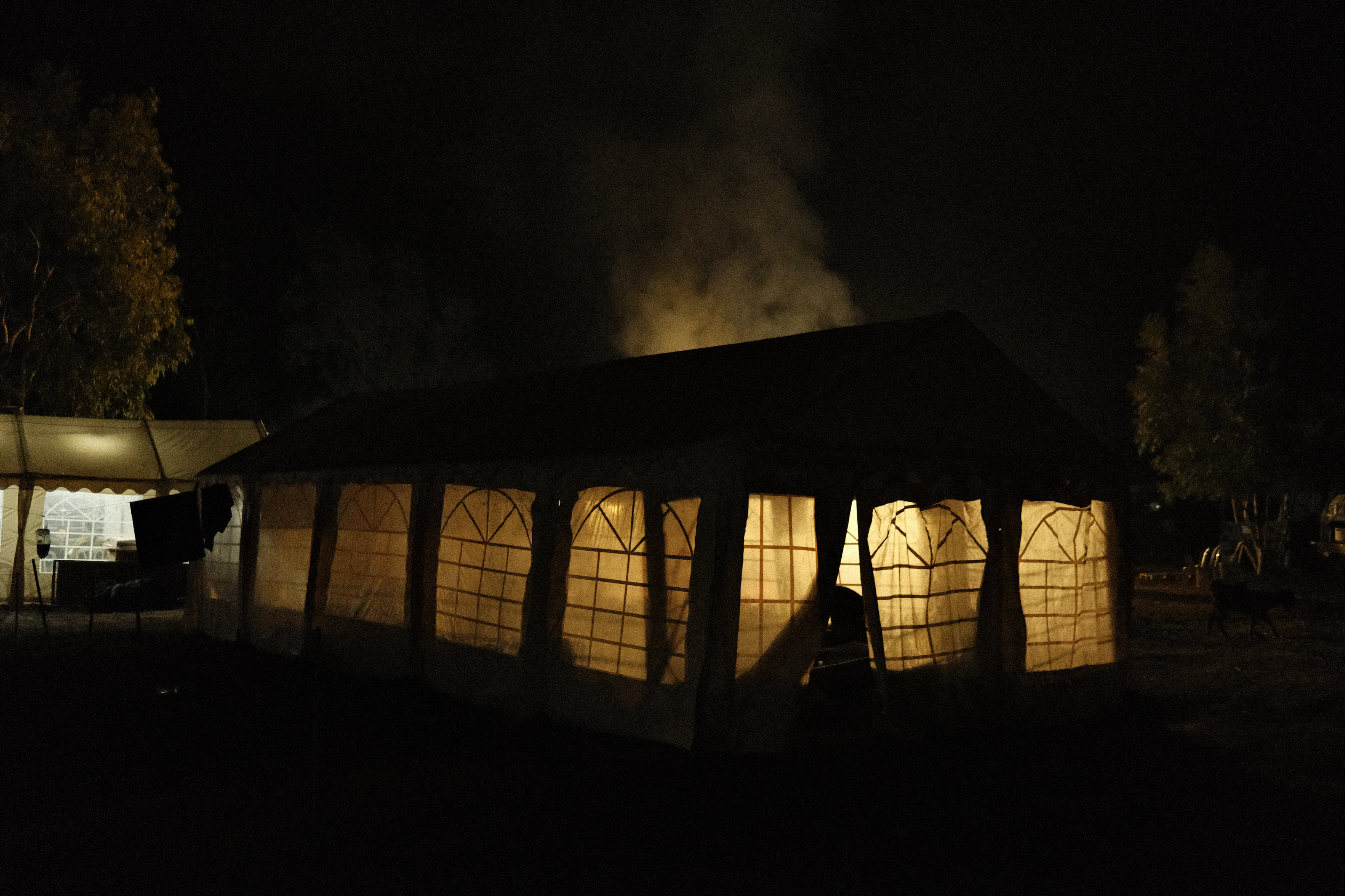 Evening cooking and bonfire behind a tent