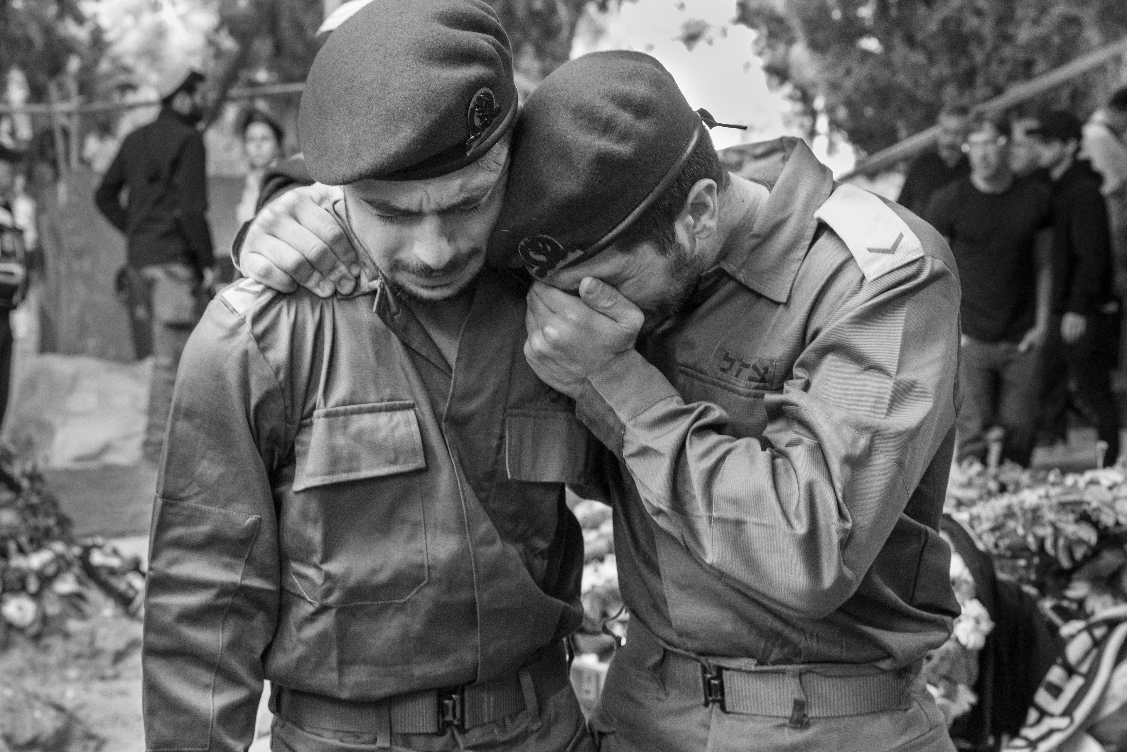 Yosef Doran's friends cry at his funeral