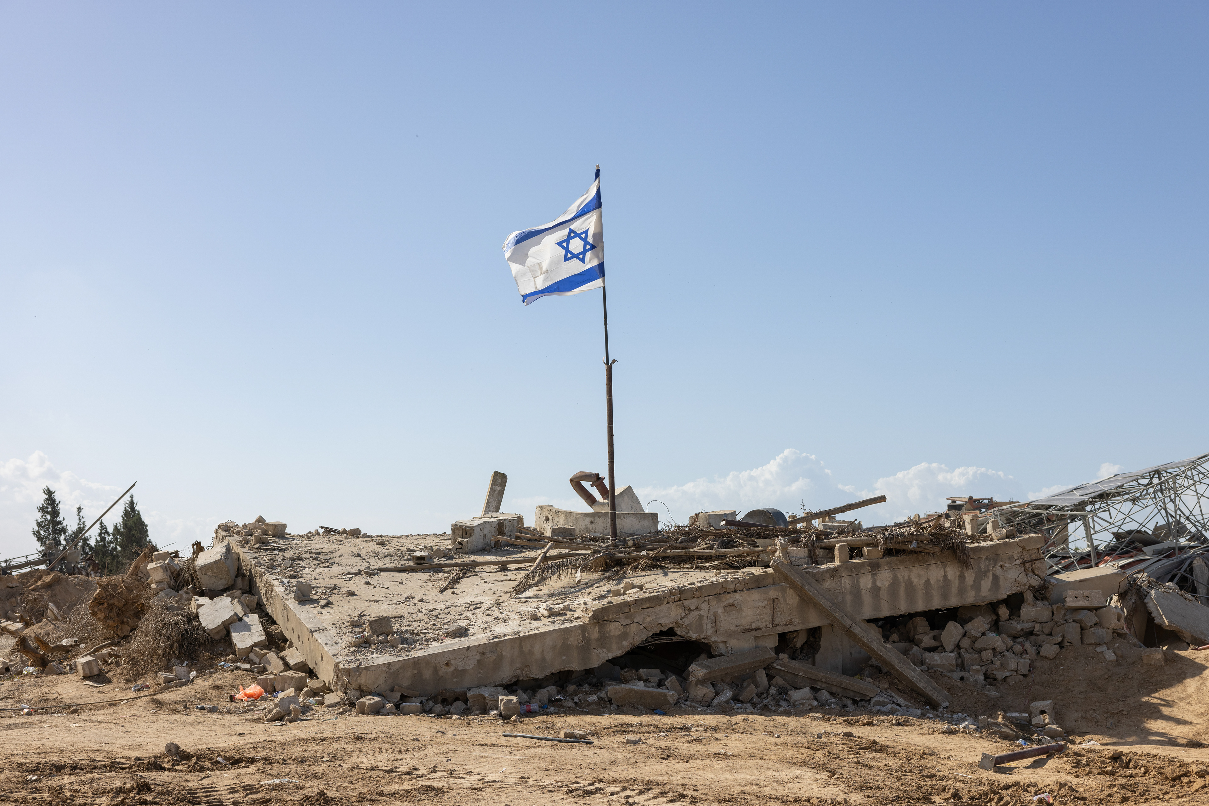 A flag is hoisted over the ruins