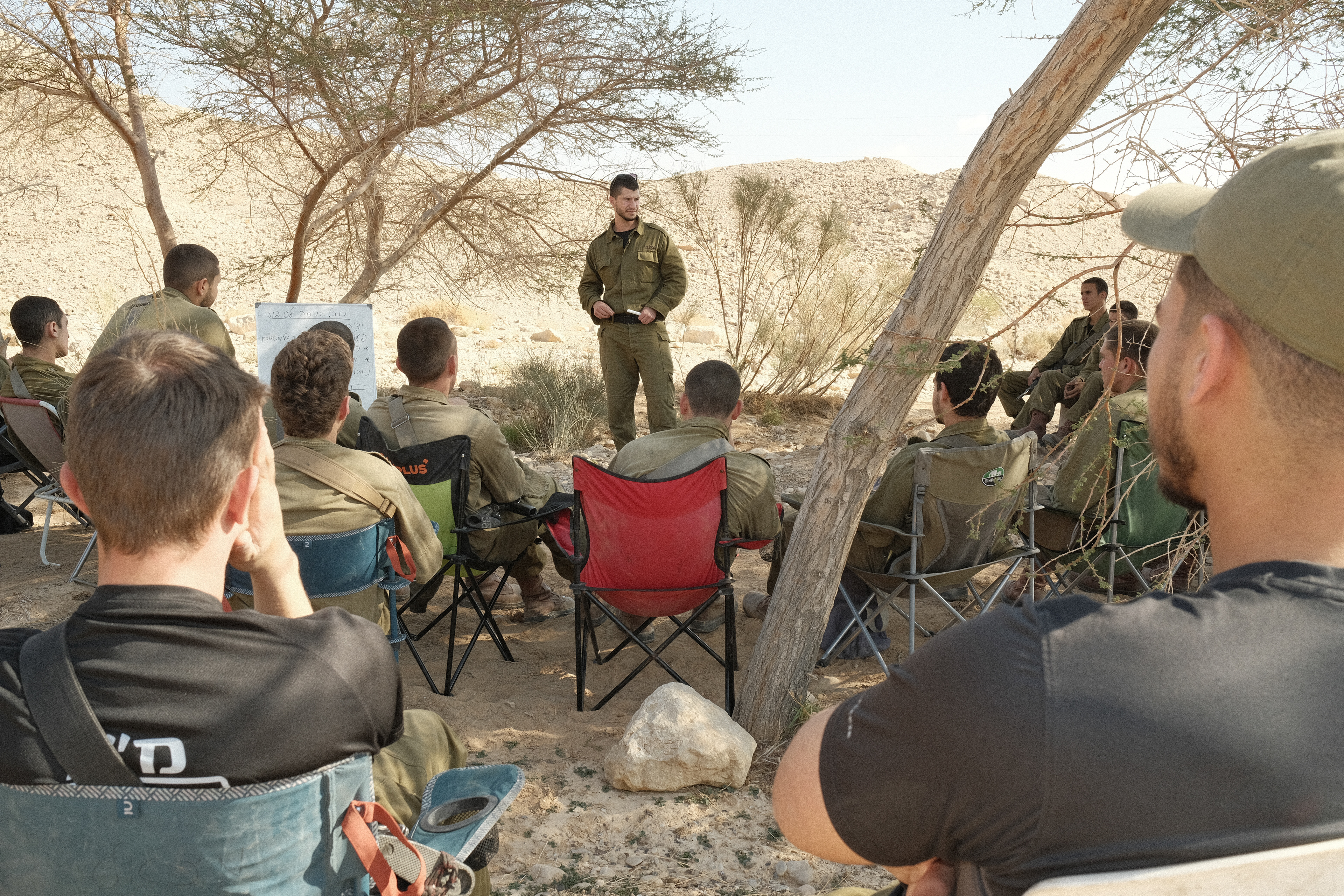 Yaron explains to young soldiers about driving in desert terrain conditions