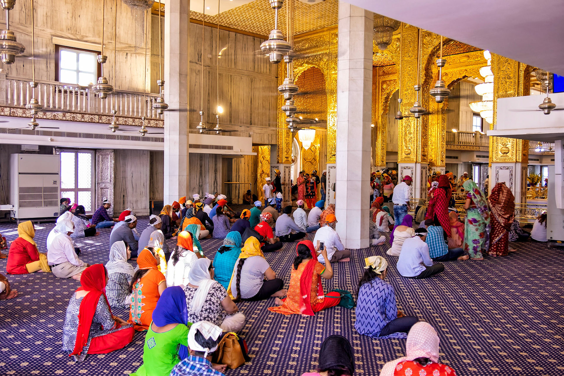 People listening to religious leader, Sikh temple