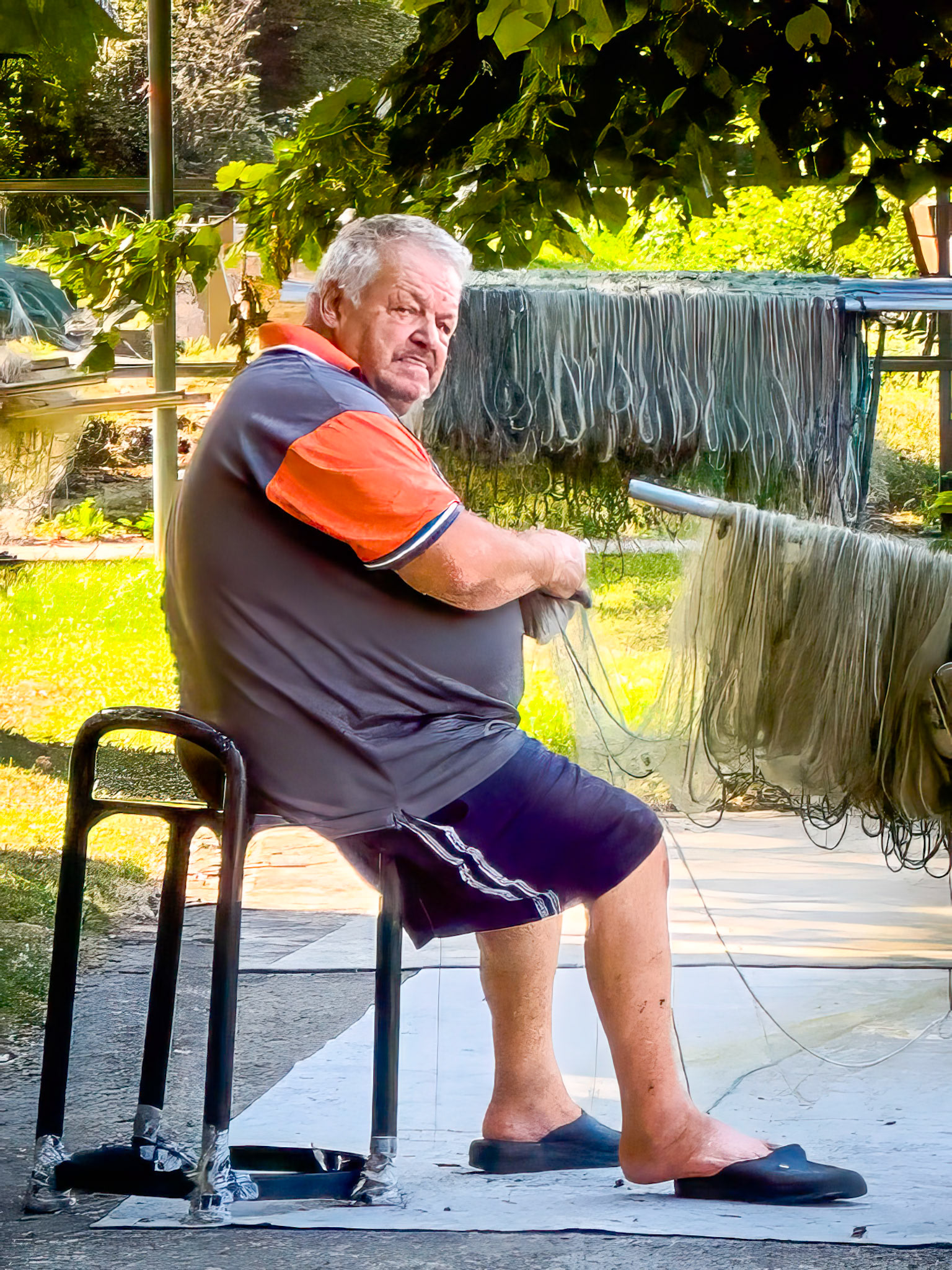 Fisherman mending nets, Lecco, Italy