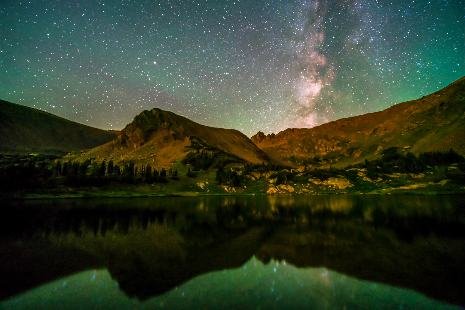 On the first night of a backpacking trip in the Front Range Mountains of Colorado, I wanted to catch the stars and Milky Way core set over the US Continental Divide. I waited patiently for the moon to set behind the Continental Divide around midnight before I gathered this 195 second integration of exposures. I was especially happy to capture the stillness of that late summer night through the starry reflection in this high alpine lake.