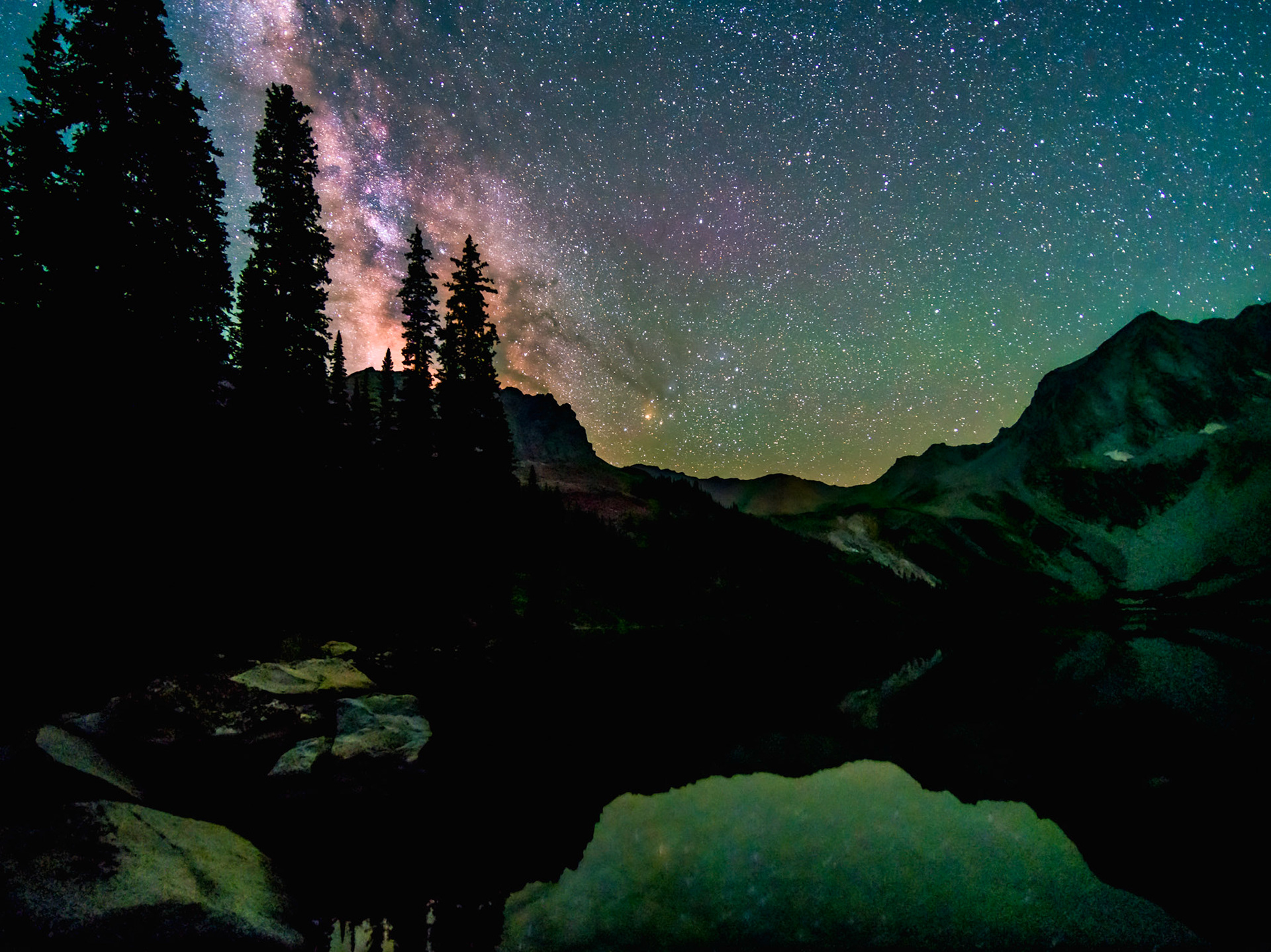 STACKEDLocation: Maroon Bells-Snowmass Wilderness, Colorado Story: While backpacking the legendary Four Pass Loop in August of 2021, there was a break in heavy monsoonal conditions that provided a window of opportunity to enjoy this tranquil scene under clear, Bortle 2 skies. The rains provided a great reminder of the dynamic nature of the Elk Range. Rockfalls were observed throughout the loop and a colossal rockfall/rock avalanche occurred on the mountain in the image several hours later. EXIF:14 * 15s @  f2.0 &amp; ISO 6400
