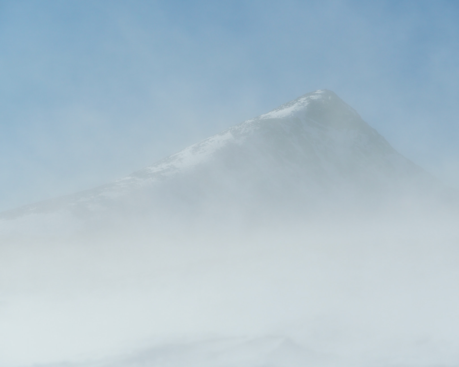 I set out snowshoeing on a bluebird day for the Continental Divide in the Arapaho and Roosevelt National Forest looking to capture bold black and white scenes. However, as I ascended above treeline, it became apparent that the wind had other plans for my day. Nonetheless, I charged into the increasingly strong headwinds towards the summit of the Continental Divide in hopes of capturing a worthy scene. When I made it to the summit of the Continental Divide, I was in a full ground blizzard and visibility rarely exceeded a few meters. The only thing in my view at times was this prominent peak so I waited for the visibility to clear just enough to capture this abstract mountain scene.