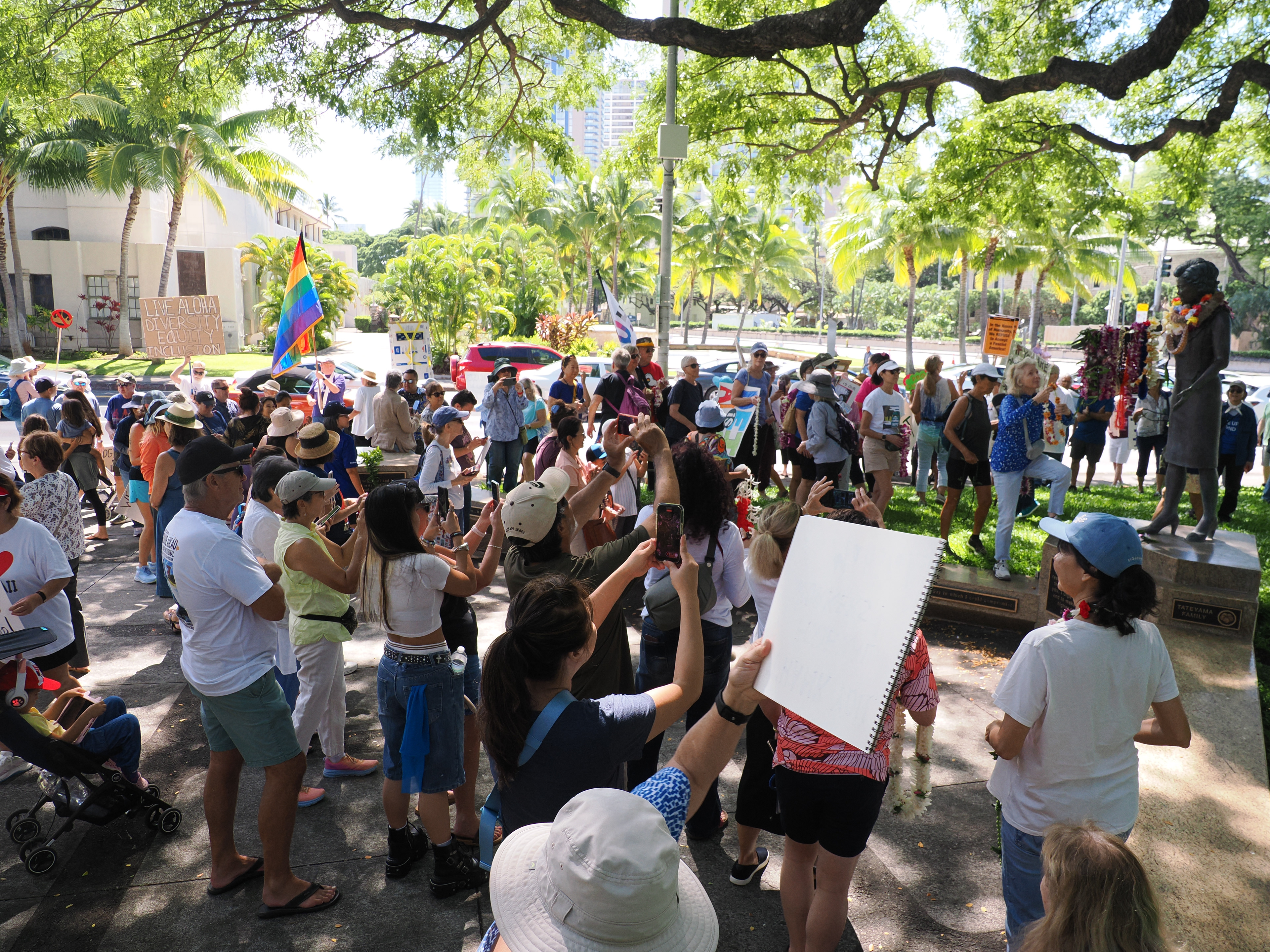 Allies pause at the statue of Patsy Mink in front of the Hawai‘i State Library to offer lei in honor of her fierce devotion to DEI. 
