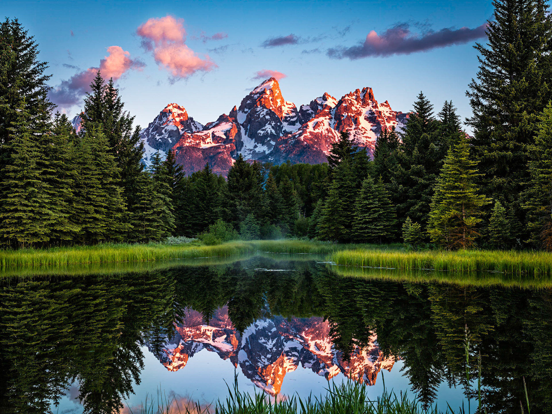 A cold and rainy evening the night before told me that of all the times I had been to Schwabacher Landing before, the next morning would be one of the most clear and still of them all. Packing my car I could see that the sky was cloudless, but since I was awake anyway I decided that there was never a bad time to visit the scenic location, regardless of conditions. Arriving an hour before sunrise, an enjoyable morning yielded perfect conditions for this famous location. Patience paid off, and my sixth visit provided the image I had always wanted.