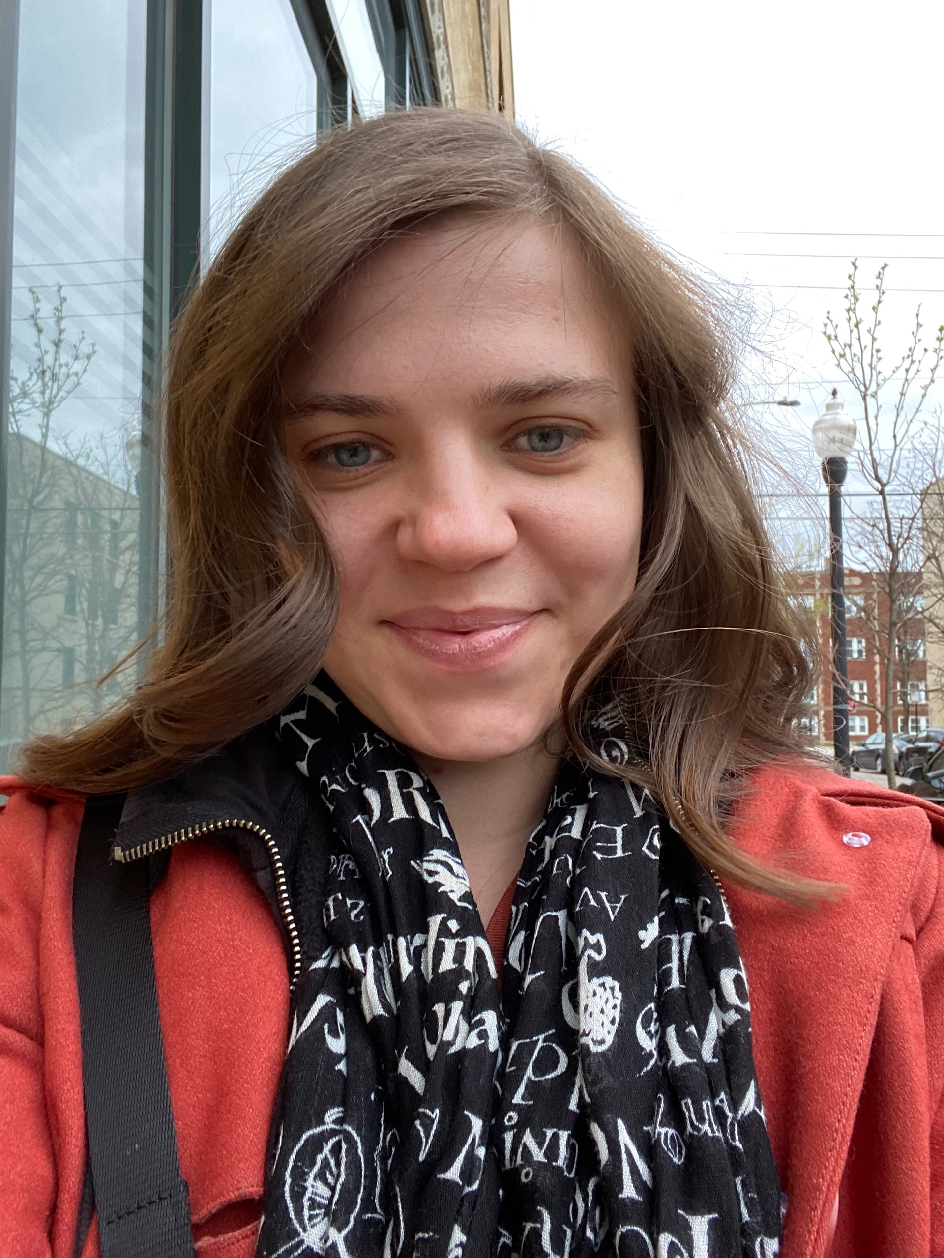 image of the designer Jessica, a young white woman looking at the camera enjoying one of the few days of Chicago Spring. 